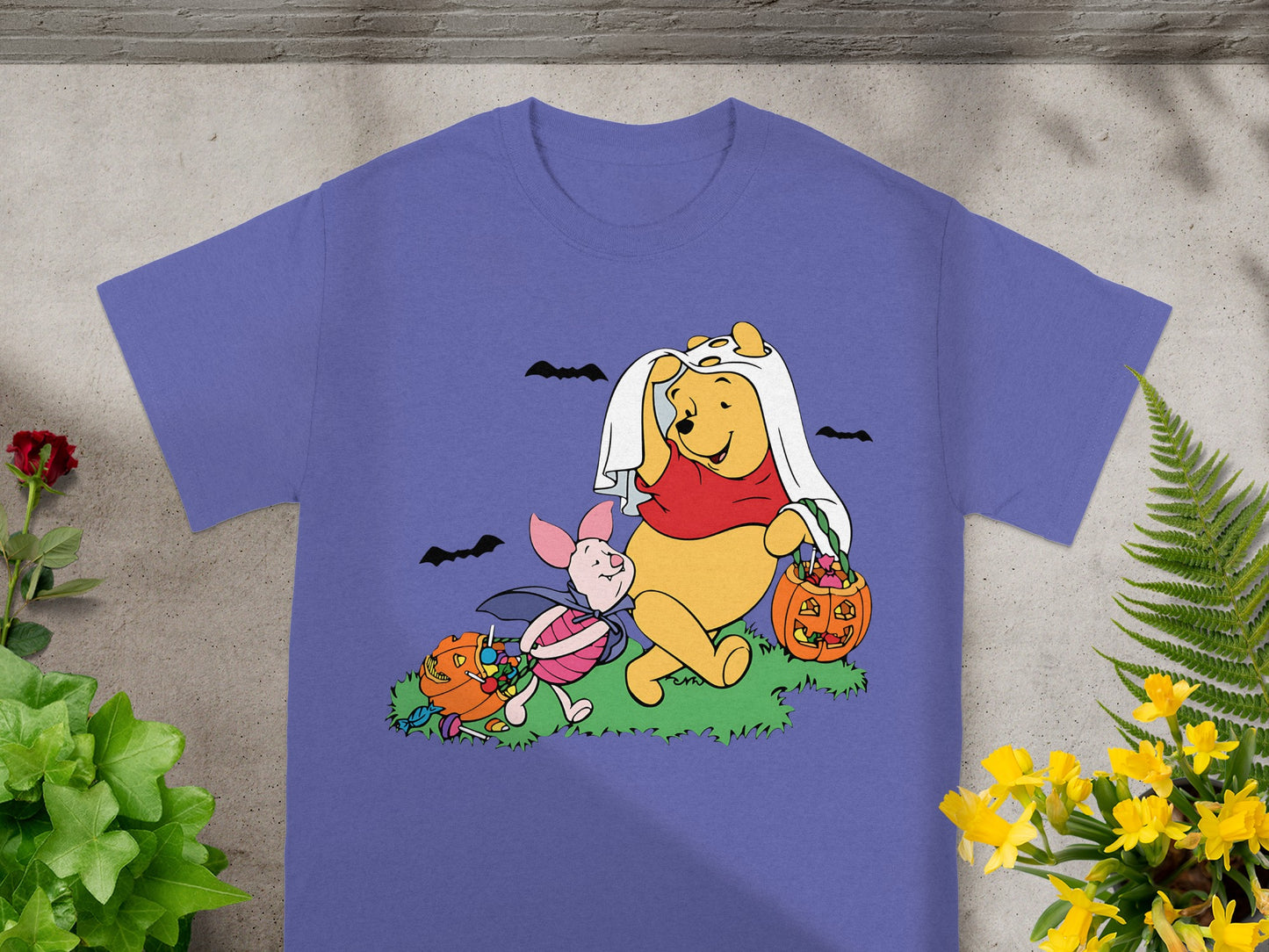 Winnie the Pooh and Piglet in Halloween costumes with pumpkins and candy.