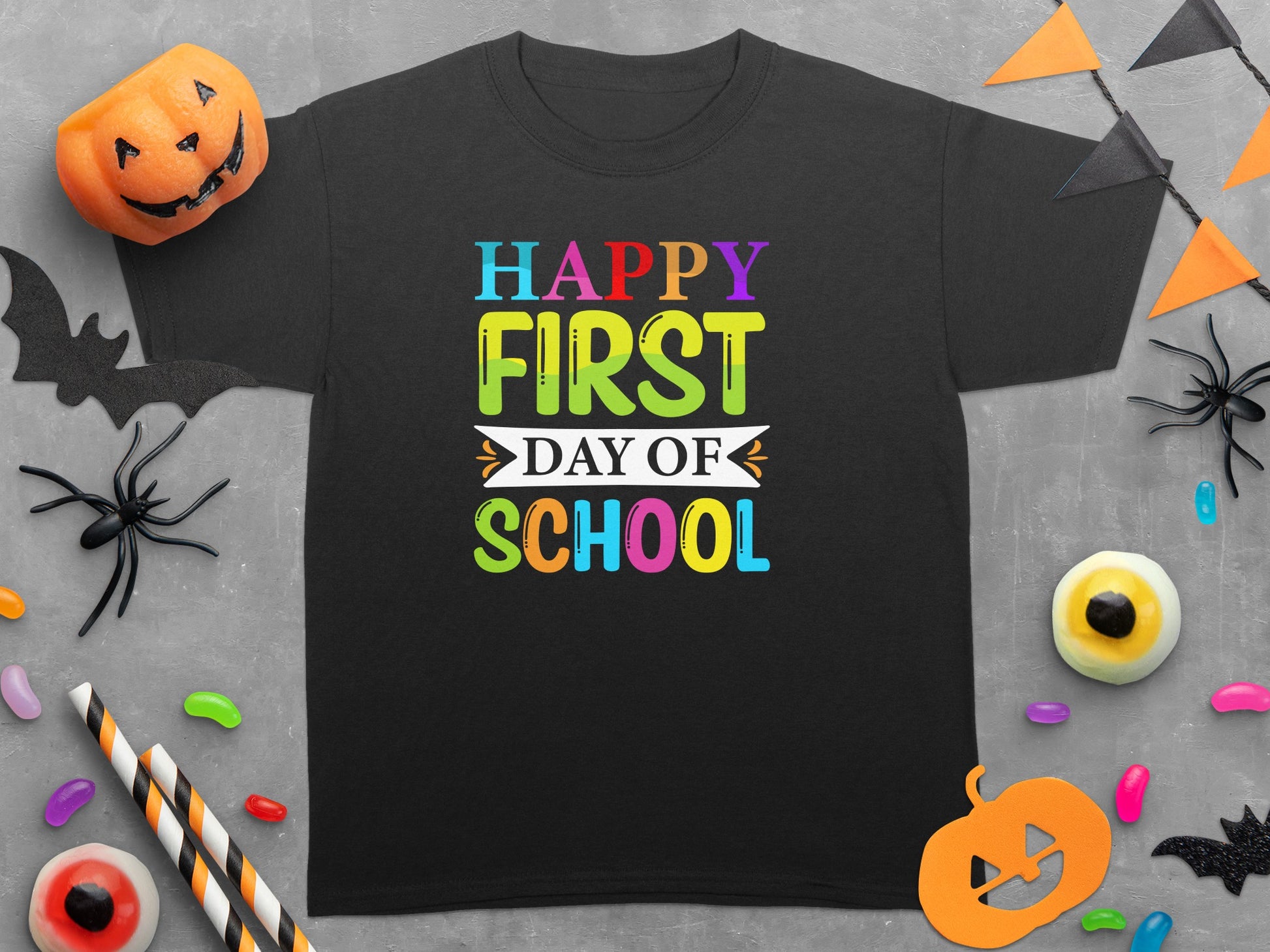 Black t-shirt with "Happy First Day of School" in colorful block letters.