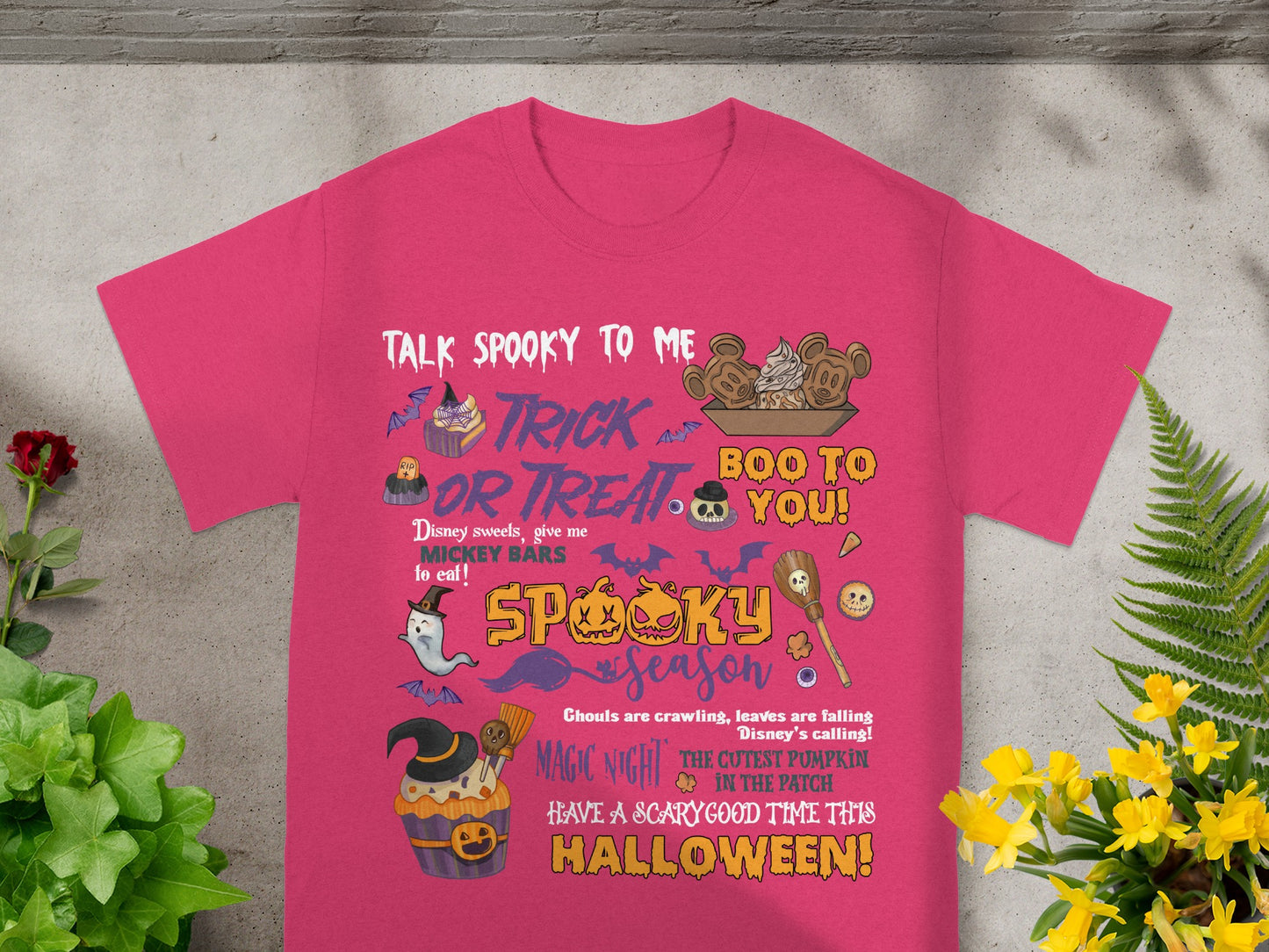 Pink t-shirt with Halloween-themed Disney graphics and text.