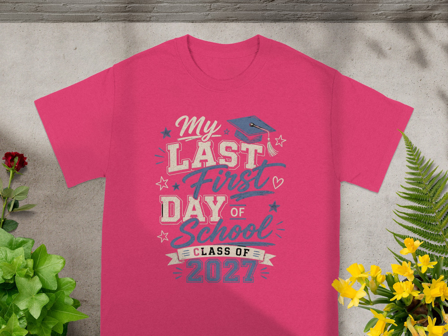 Pink t-shirt with graduation cap graphic and text "My LAST First DAY OF School CLASS OF 2027".