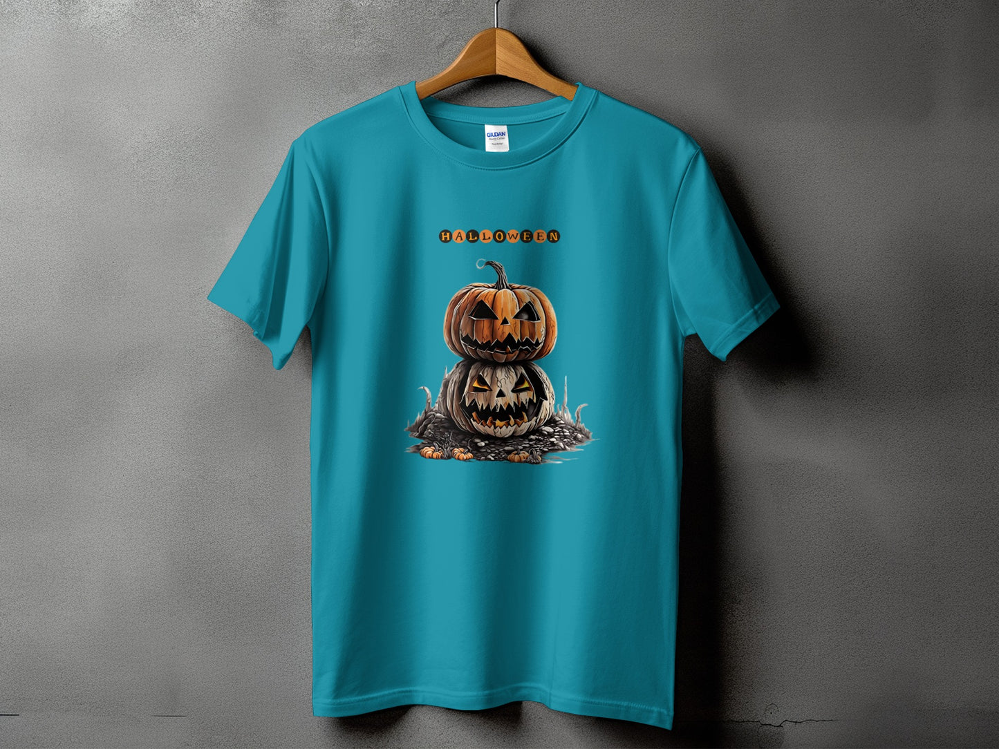 Teal t-shirt with stacked Halloween pumpkins and orange text.
