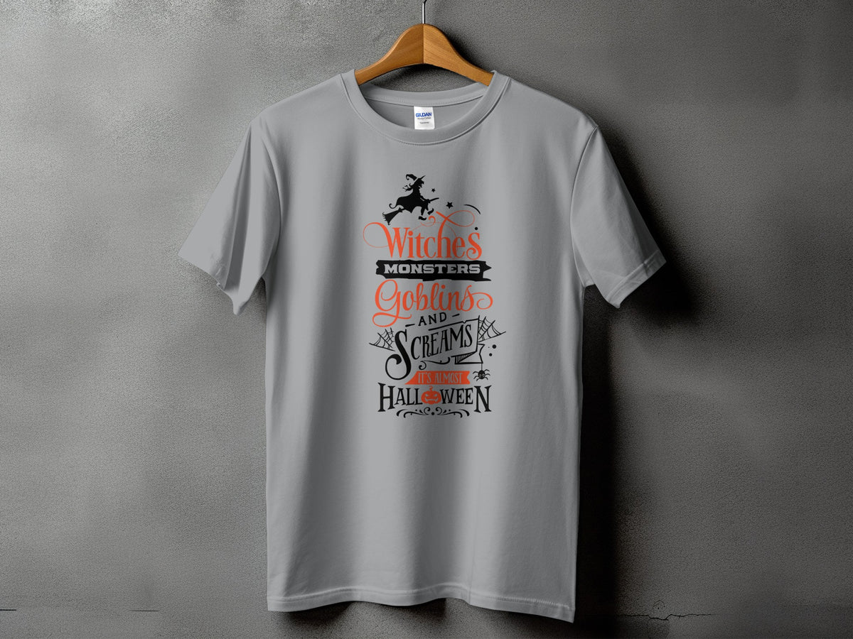 Grey t-shirt with "Witches Monsters Goblins and Screams It's Almost Halloween" text.