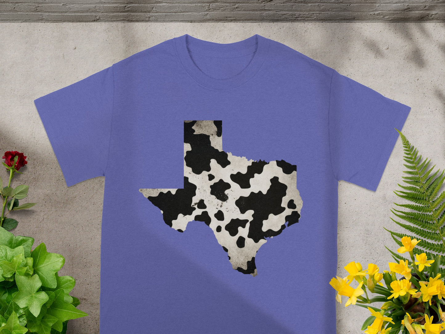 Purple t-shirt with a Texas shape in cow print pattern.