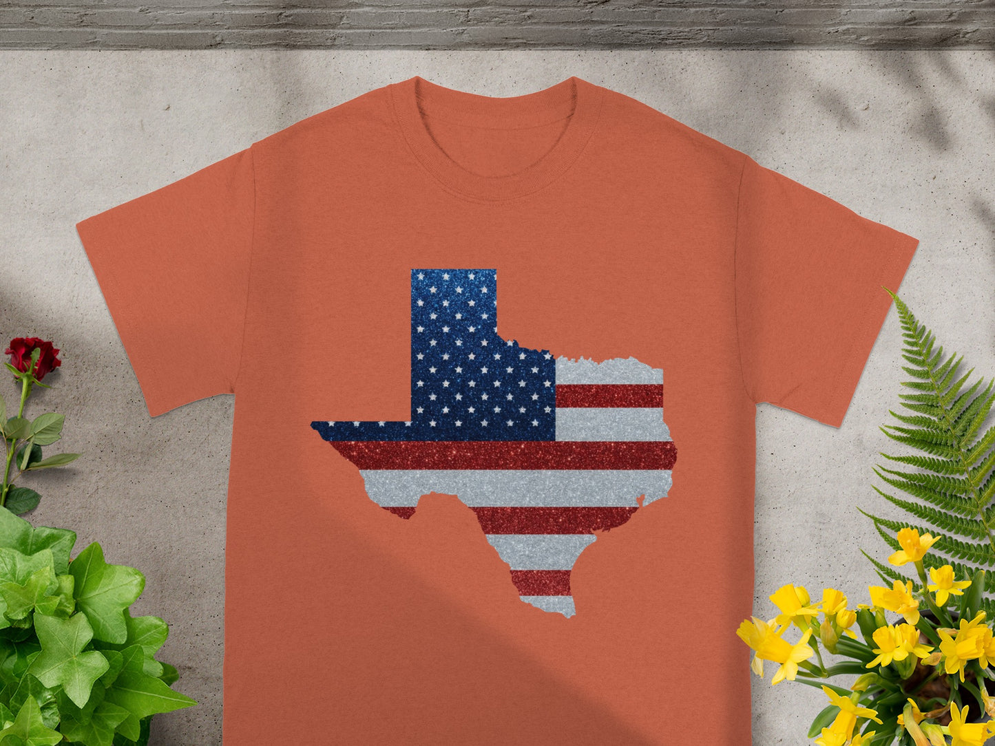 Orange t-shirt with Texas map outline filled with American flag stars and stripes.