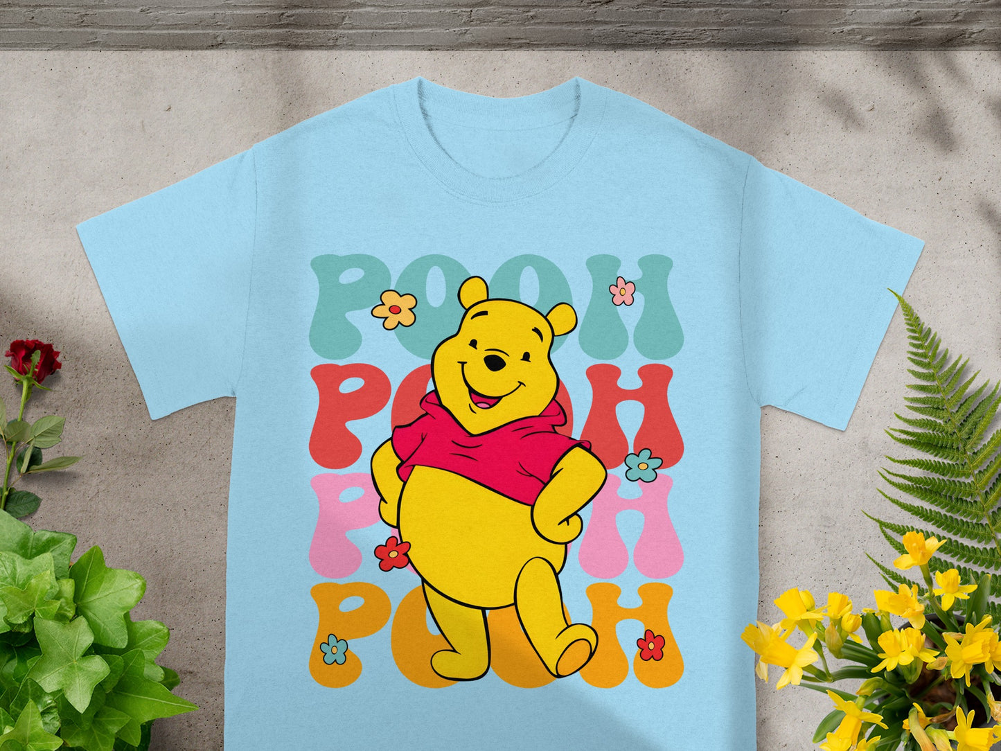Light blue t-shirt with Winnie the Pooh graphic and "Pooh" text.