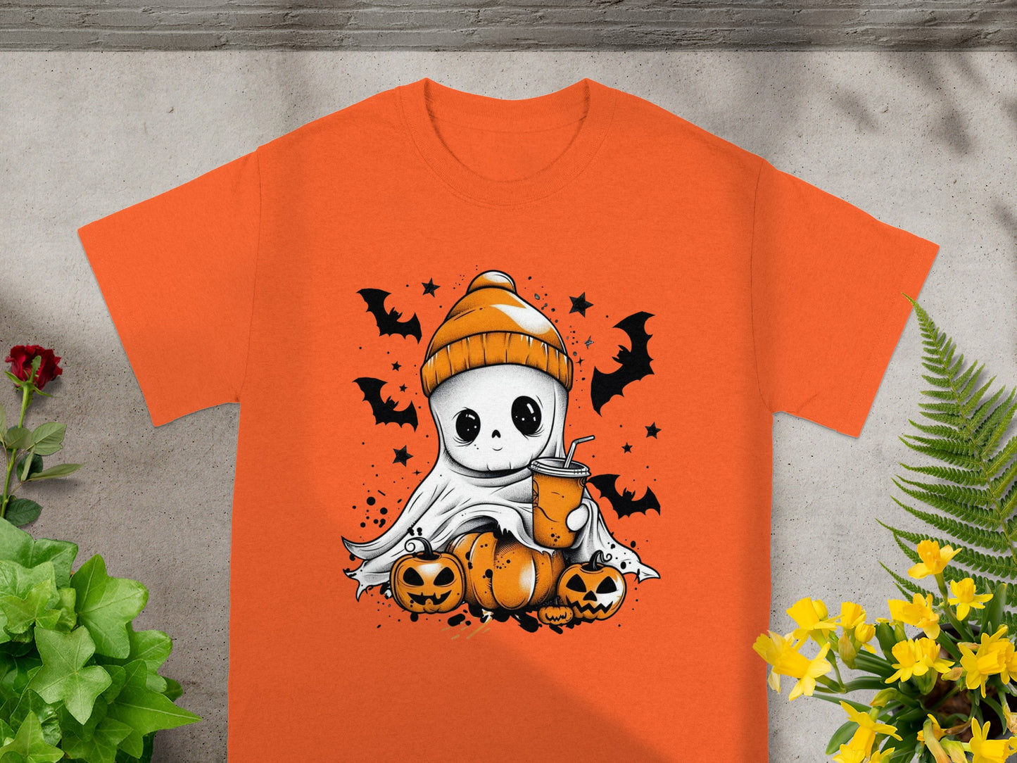 Orange t-shirt with ghost holding a drink, surrounded by pumpkins and bats.