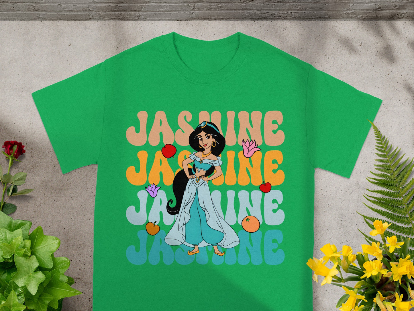 Green t-shirt with "JASMINE" in colorful, layered bubble letters.