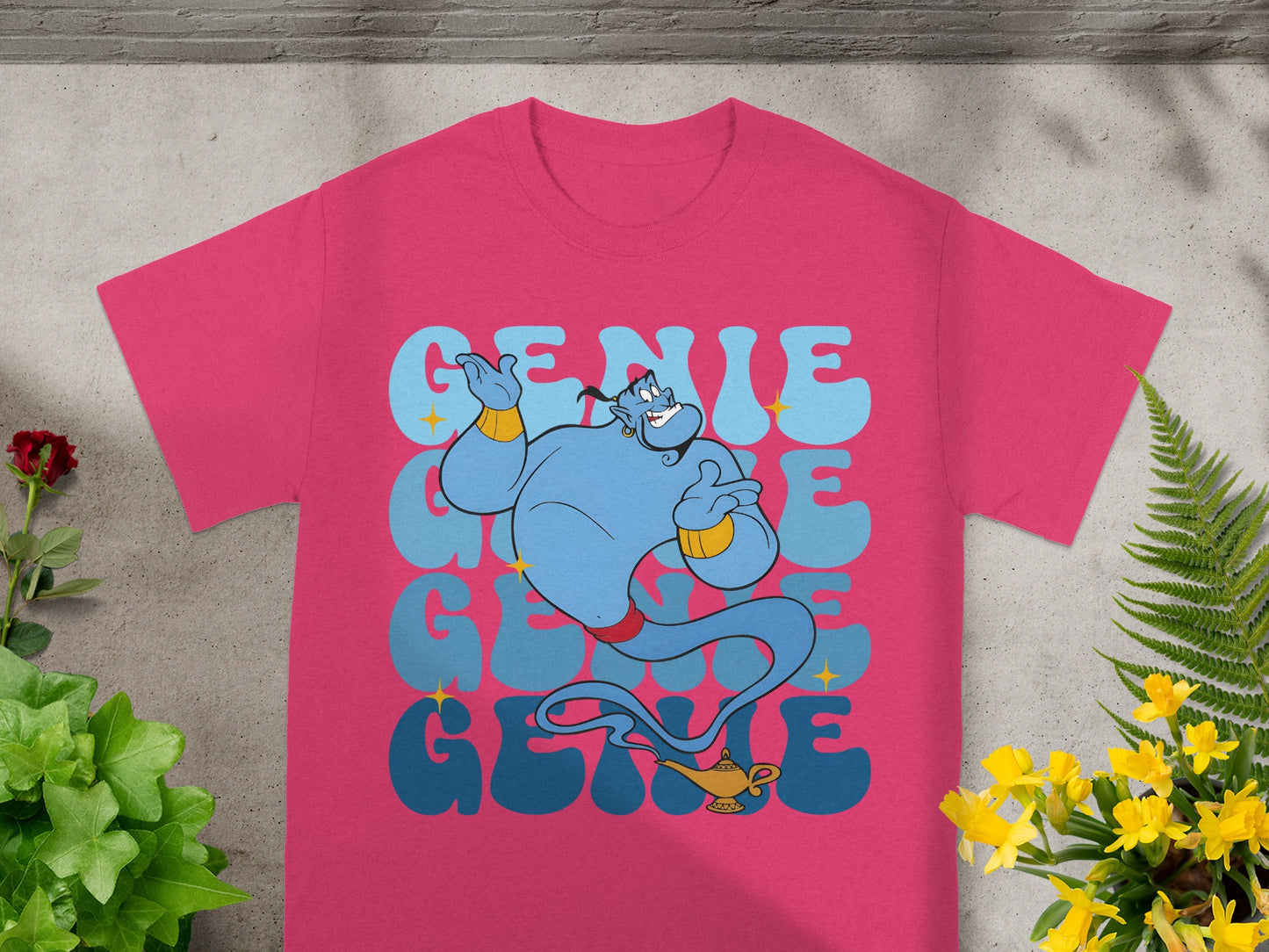 Pink t-shirt with large blue genie and "Genie" text in stacked blue and light blue letters.