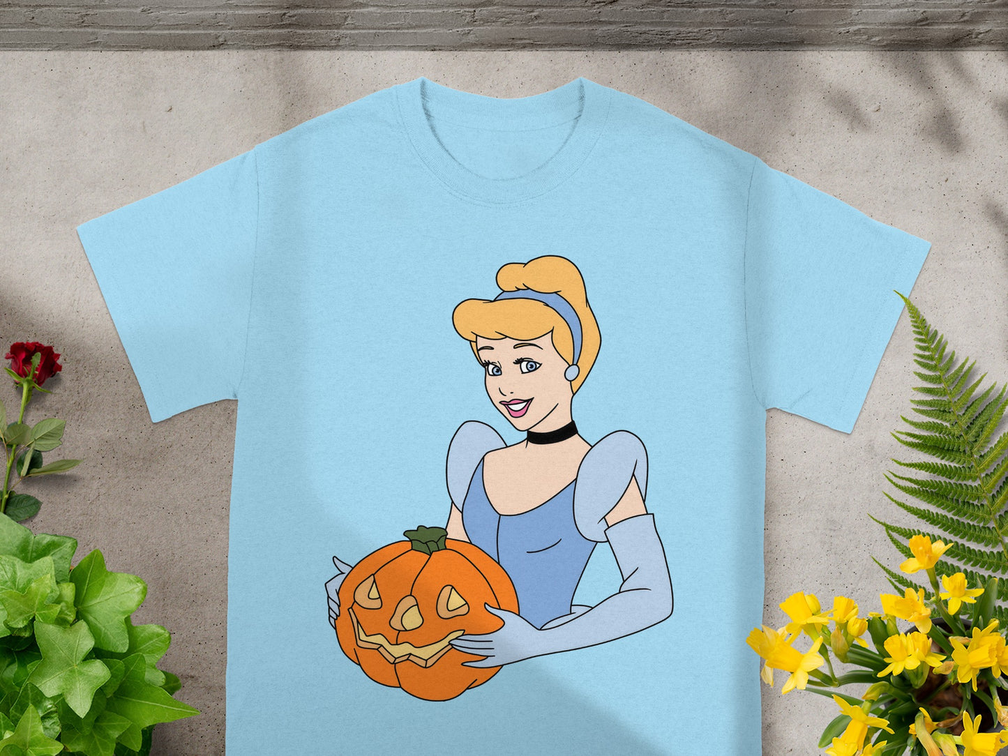 Light blue t-shirt with Cinderella holding a jack-o'-lantern.