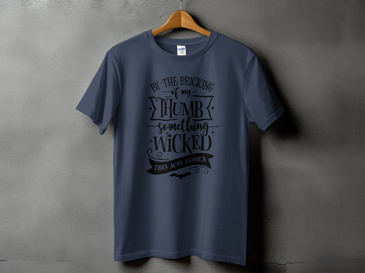 Dark blue t-shirt with black text that reads "By the pricking of my thumb something wicked this way comes".