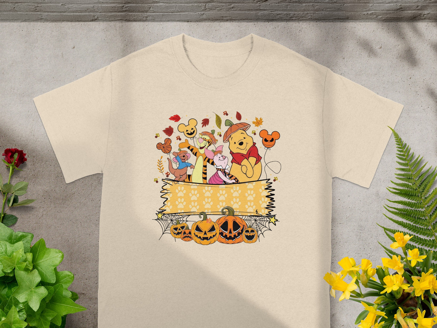 Winnie the Pooh characters with pumpkins and Halloween-themed decorations.