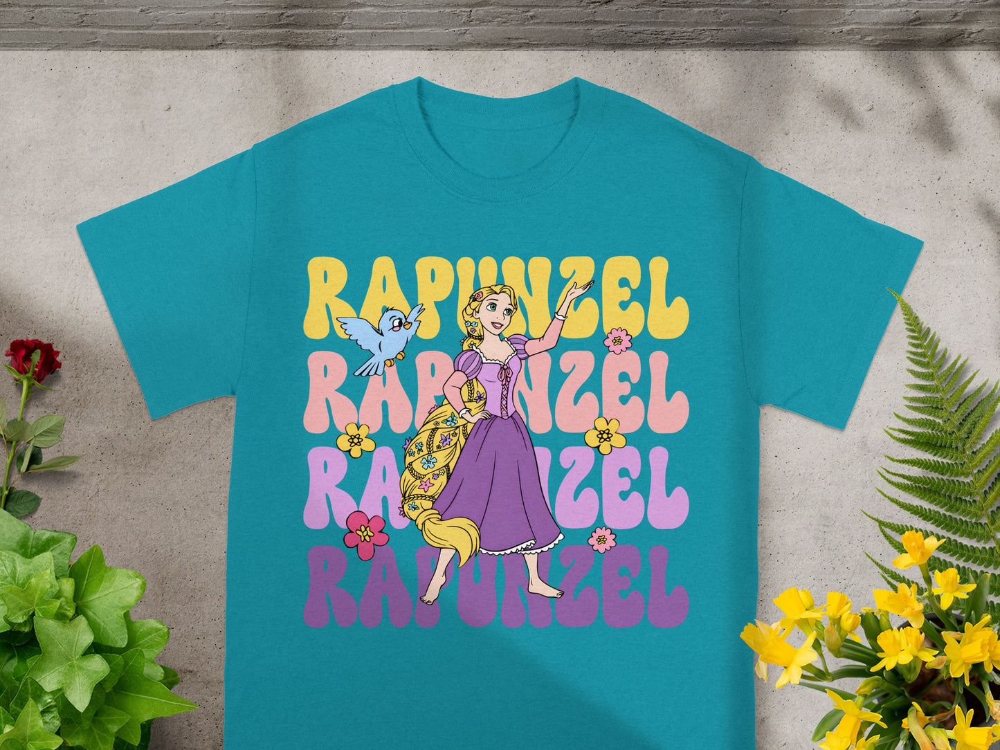 Teal t-shirt with Rapunzel in colorful retro lettering.