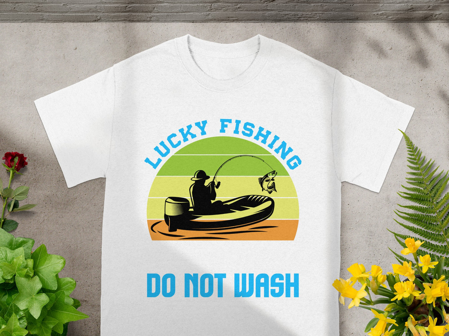 White t-shirt featuring a graphic of a fisherman in a boat with text "LUCKY FISHING" and "DO NOT WASH".