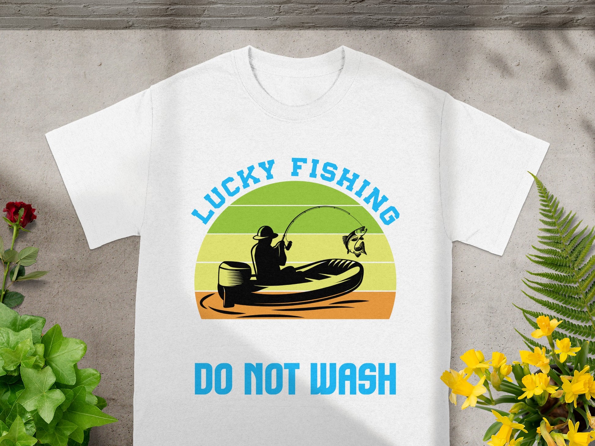 White t-shirt featuring a graphic of a fisherman in a boat with text "LUCKY FISHING" and "DO NOT WASH".