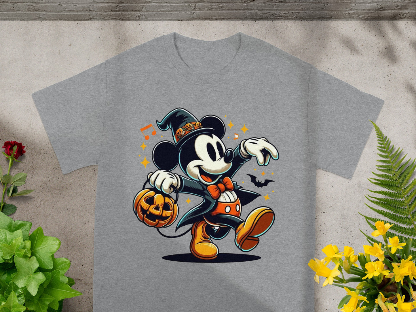 Mickey Mouse in a witch hat holds a jack-o'-lantern on a grey t-shirt.