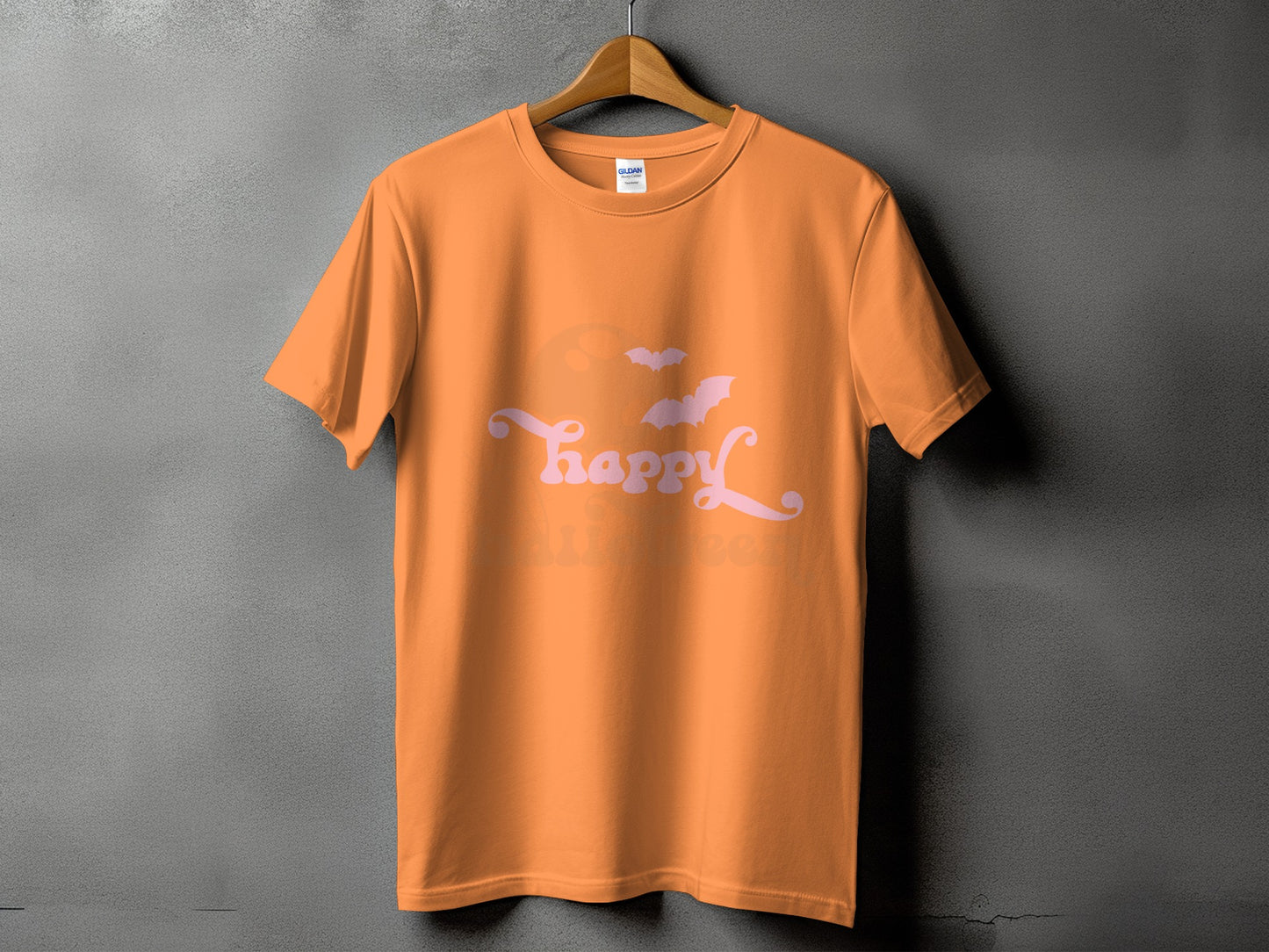 Orange t-shirt with pink "Be happy Halloween" text and bats graphic.