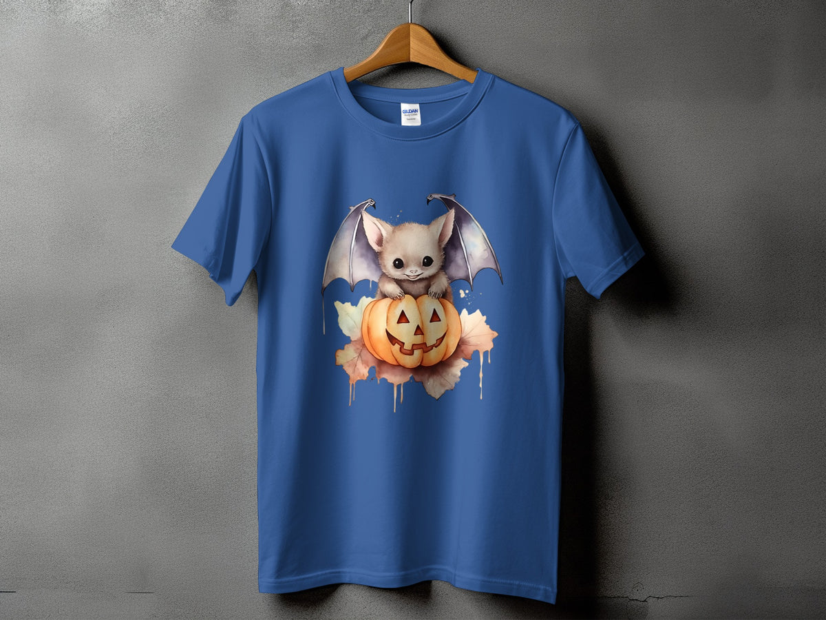 Blue t-shirt with cute bat sitting on a carved pumpkin with autumn leaves.
