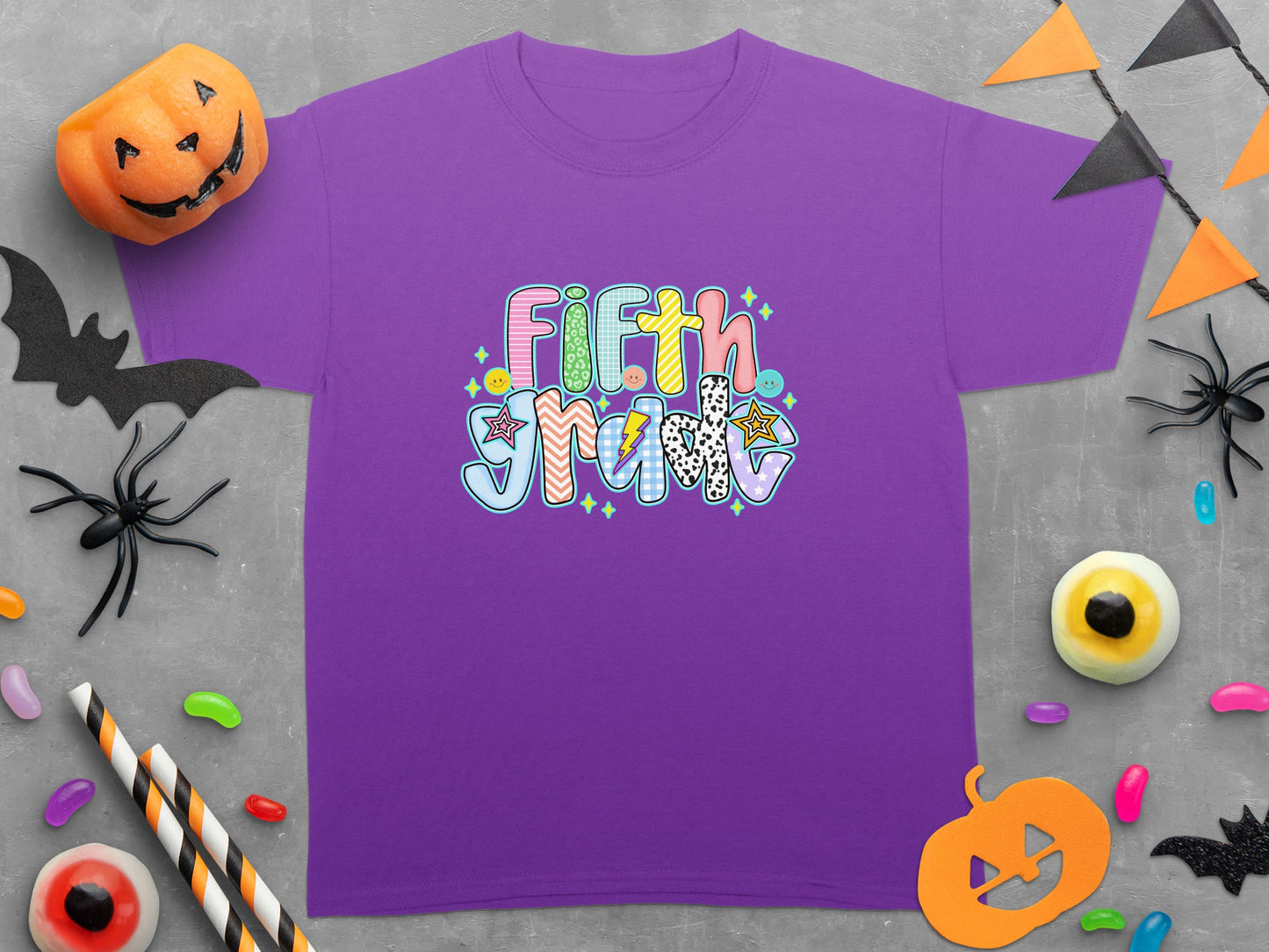 Purple t-shirt with "Fifth Grade" in colorful, patterned letters.