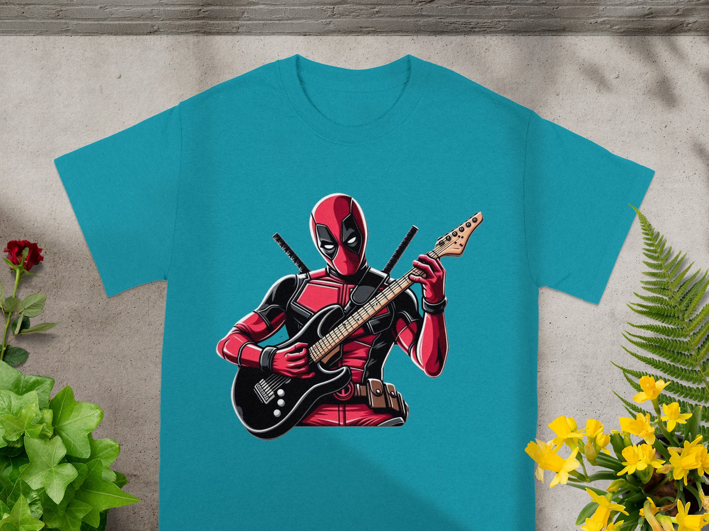Turquoise t-shirt with Deadpool playing a black electric guitar.