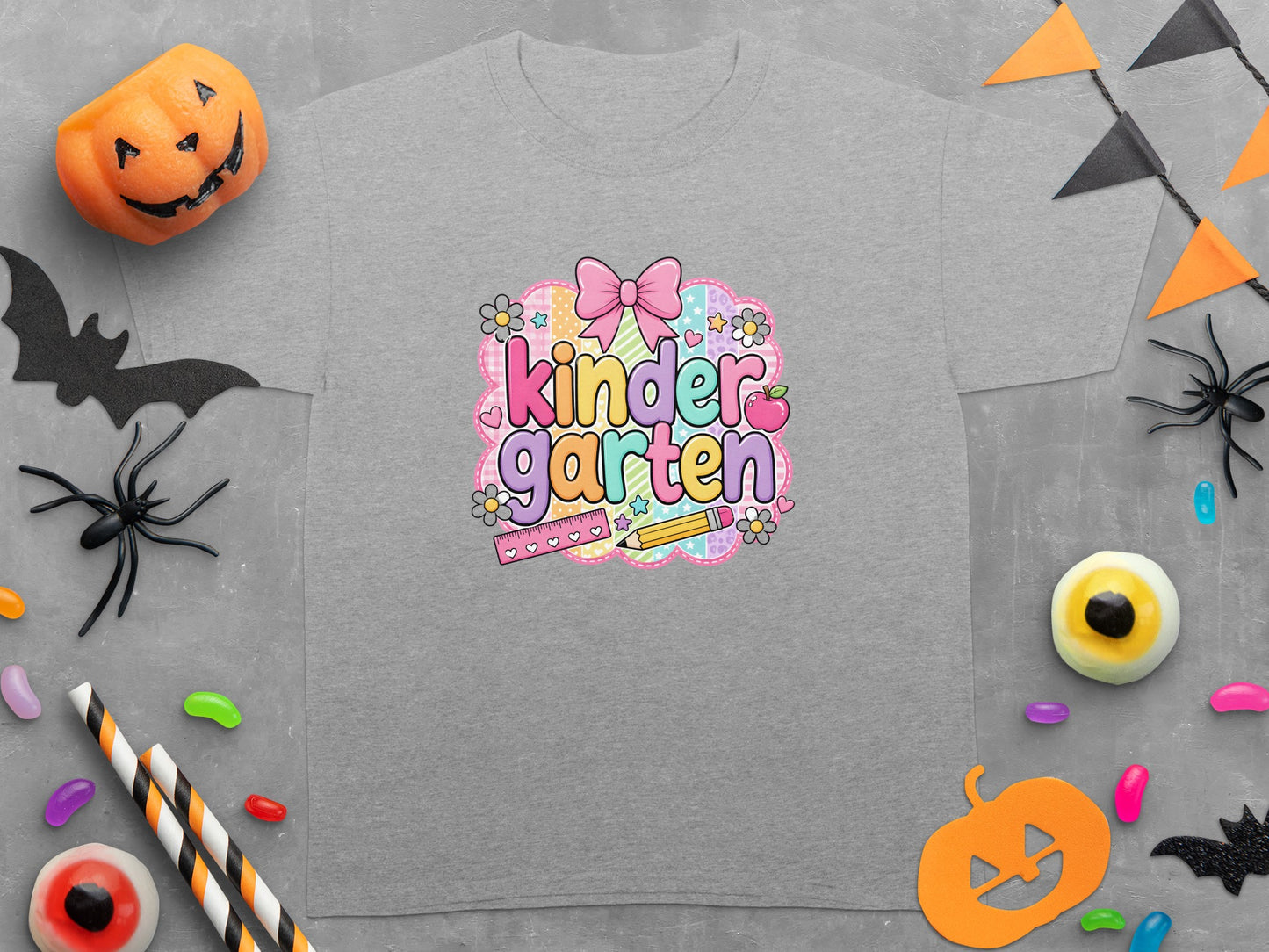Gray t-shirt with 'kindergarten' text, bow, ruler, pencil, and Halloween decorations.