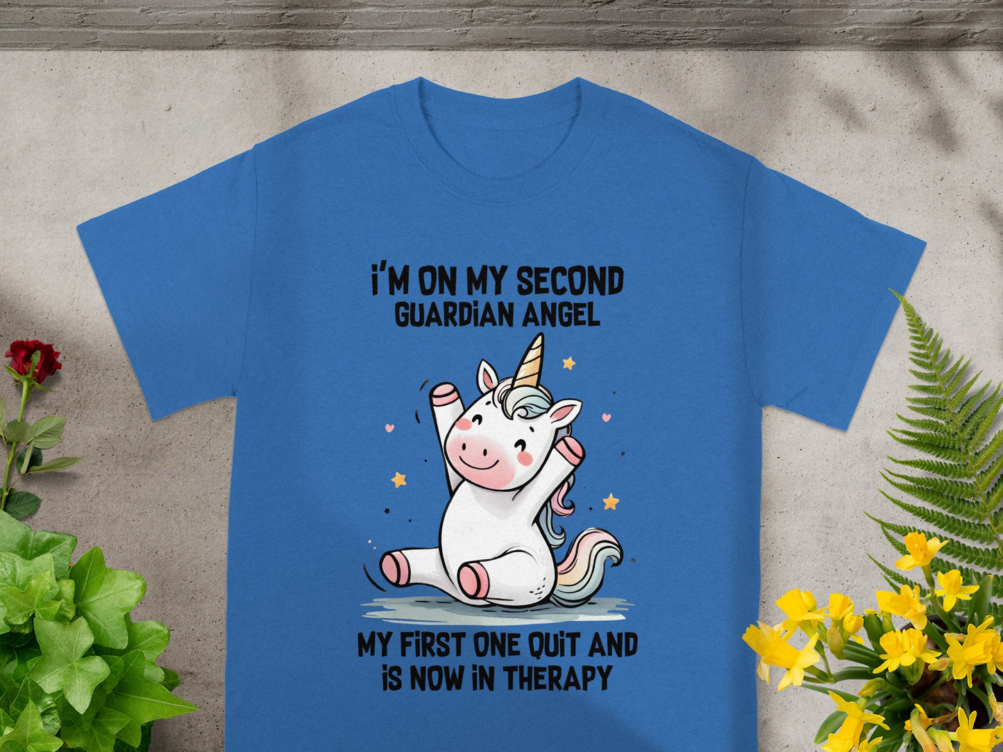 Blue t-shirt with a unicorn graphic and text "I'm on my second guardian angel."