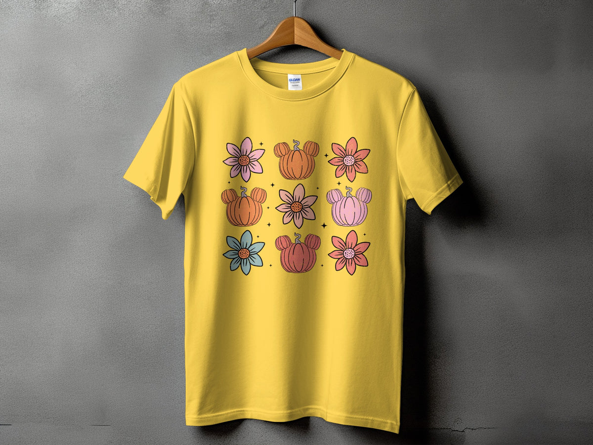 Yellow t-shirt with a grid of colorful flowers and Mickey-shaped pumpkins.