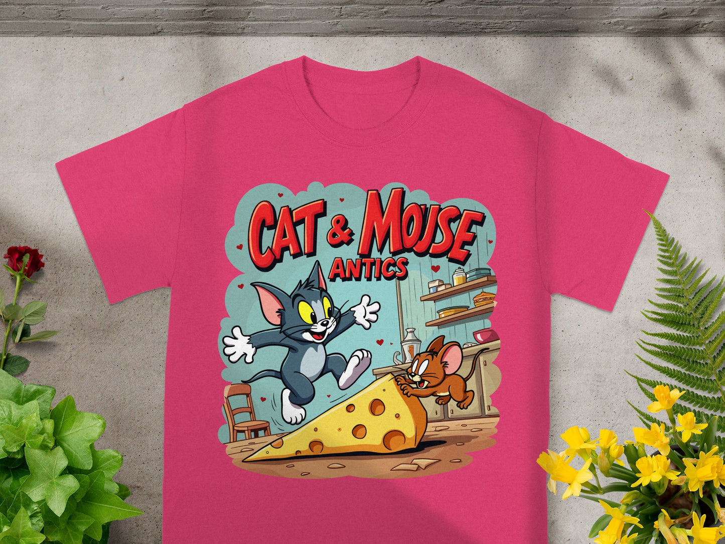 Tom and Jerry cartoon graphic on pink t-shirt with "Cat & Mouse Antics" text.