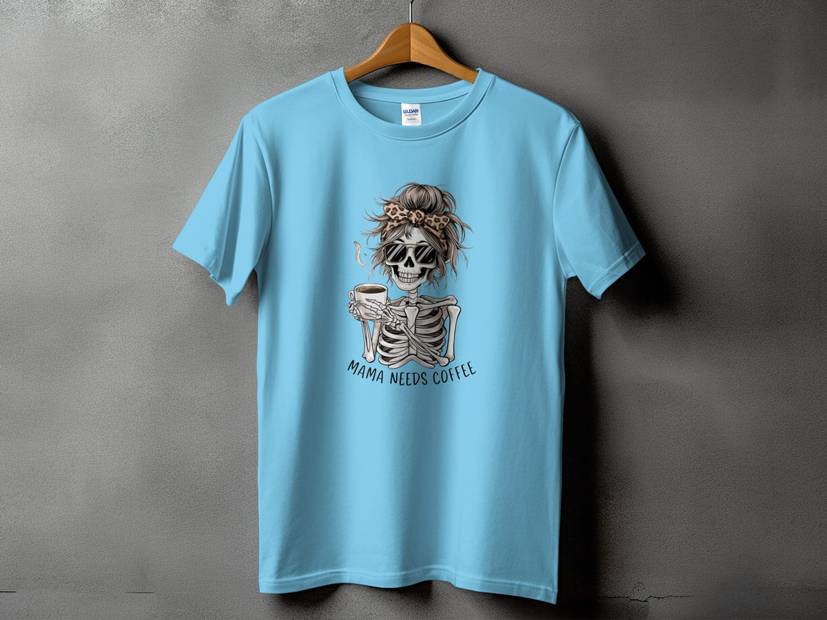 Light blue t-shirt with a skeleton graphic drinking coffee, text "Mama Needs Coffee."