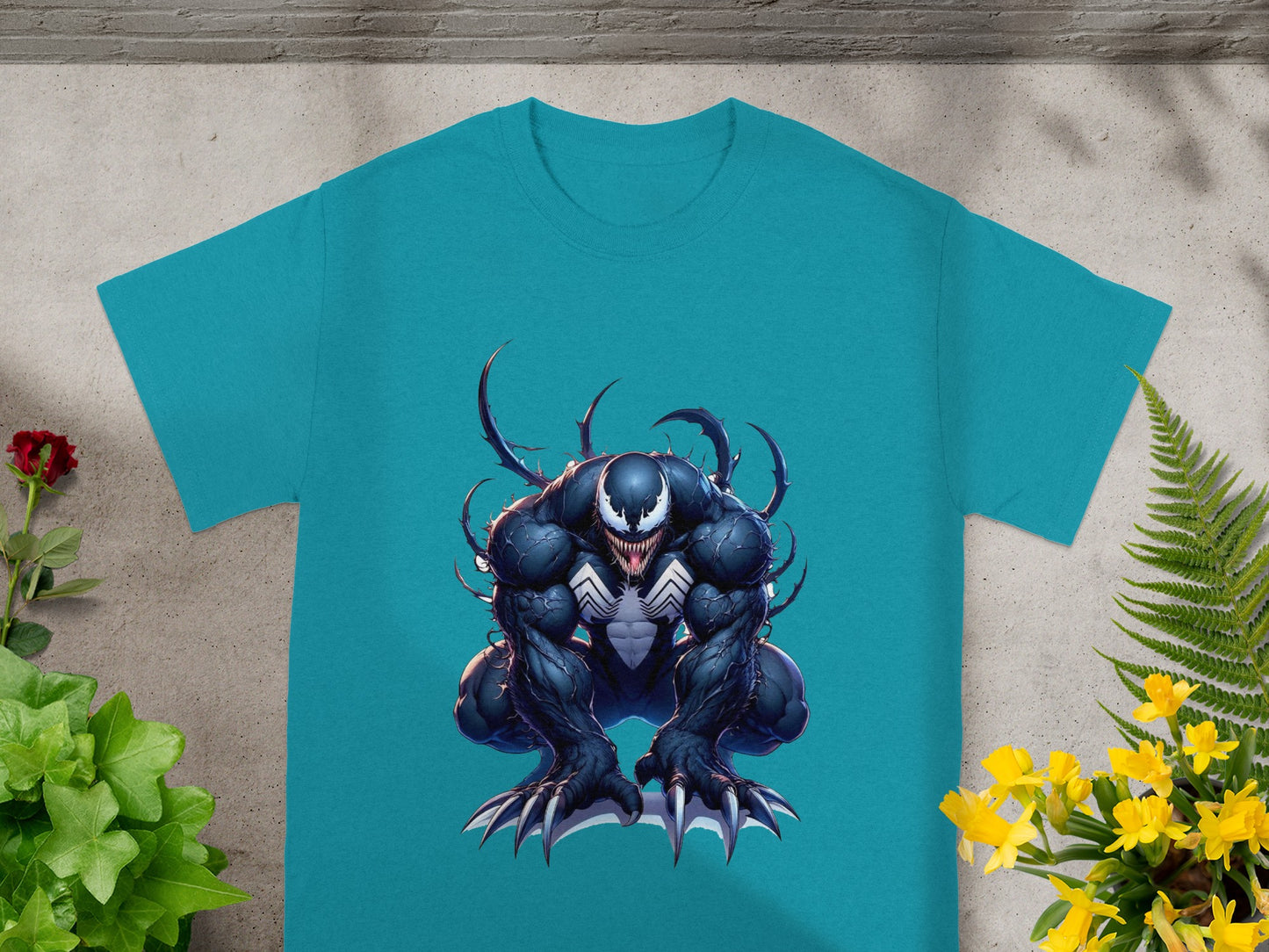 Venom character illustration on a turquoise t-shirt.