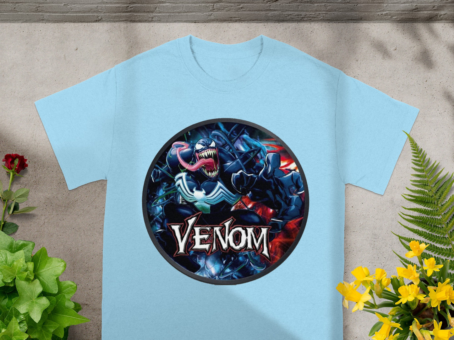 Light blue t-shirt featuring a circular Venom logo with the character's face and name.