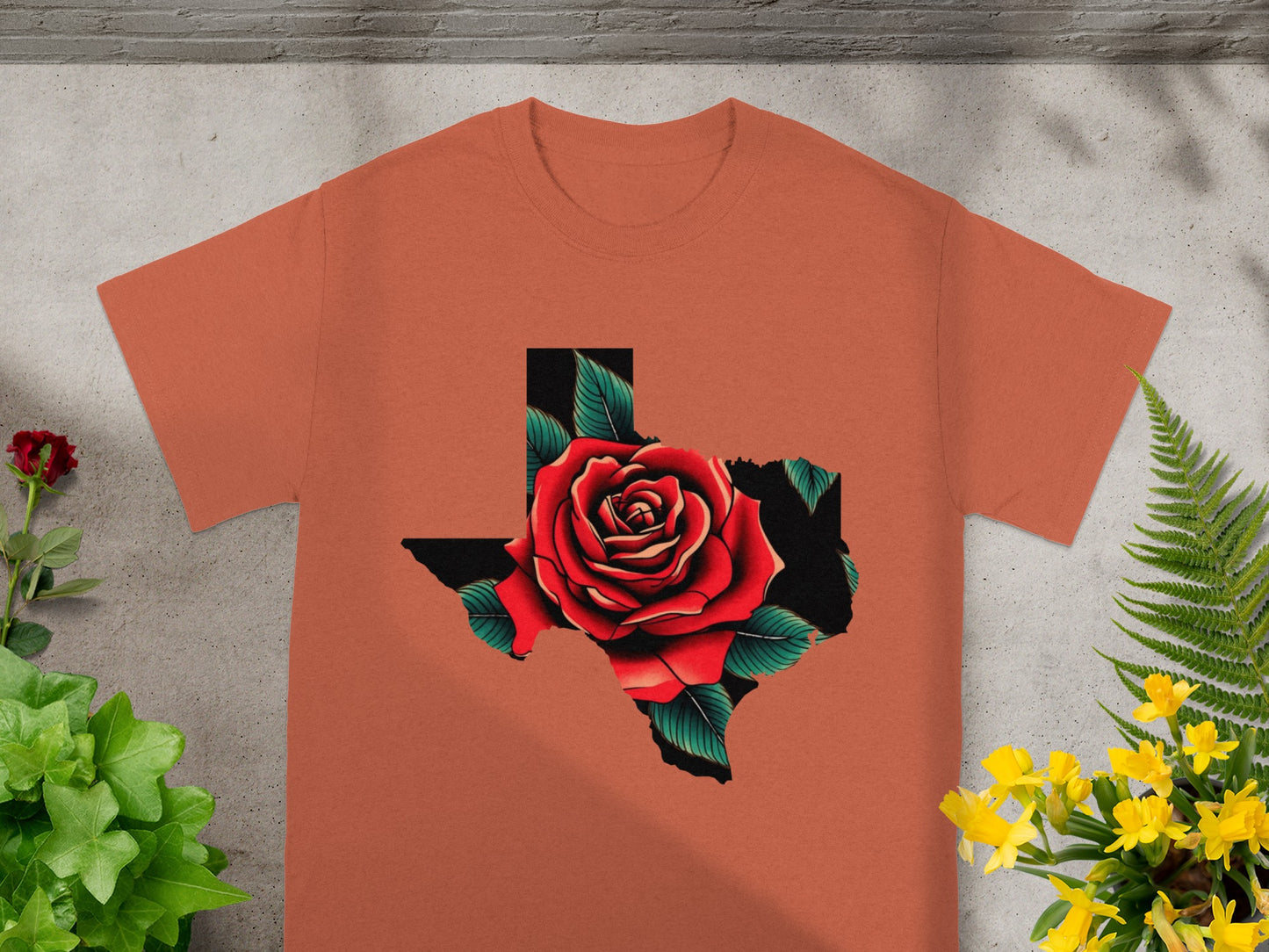 Orange t-shirt with Texas map graphic featuring a red rose and green leaves.
