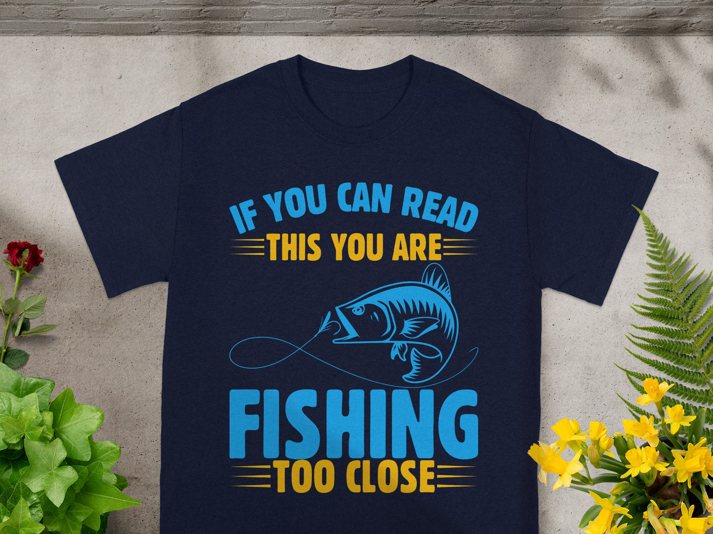 Navy t-shirt with "If You Can Read This You Are Fishing Too Close" text and fish graphic.
