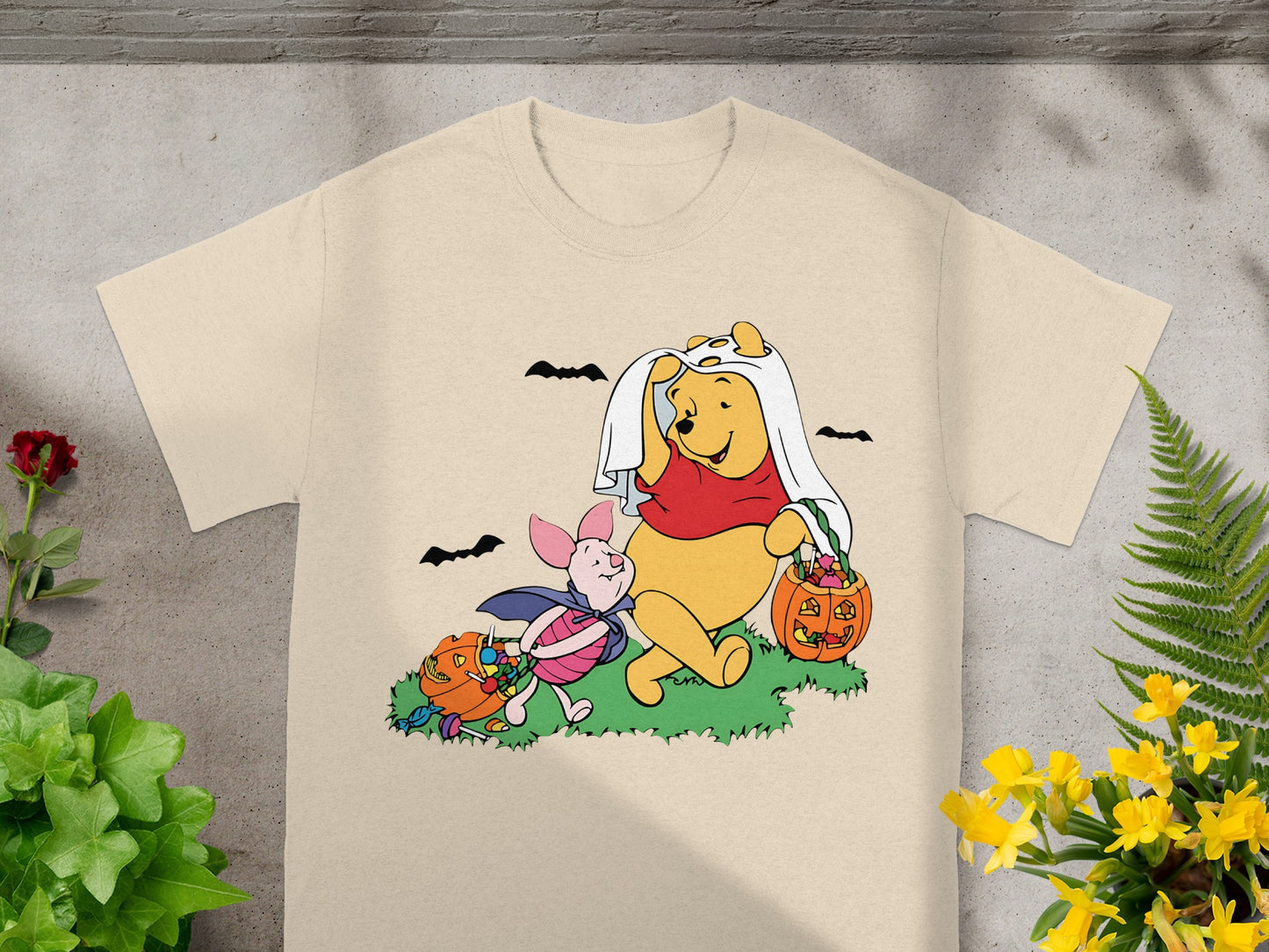 Winnie the Pooh and Piglet dressed for Halloween with candy and pumpkins.