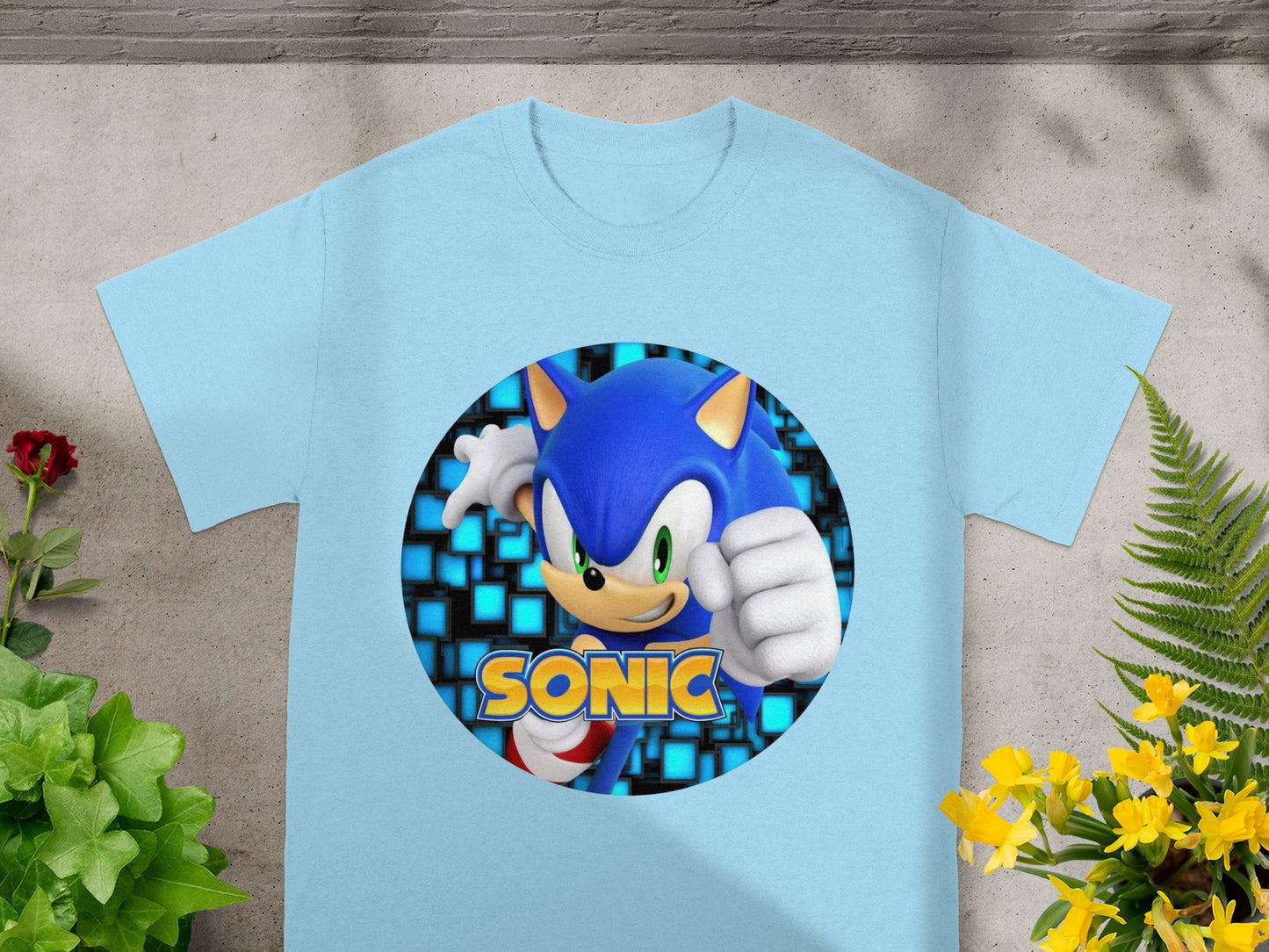 Light blue t-shirt with Sonic the Hedgehog graphic on a patterned background.