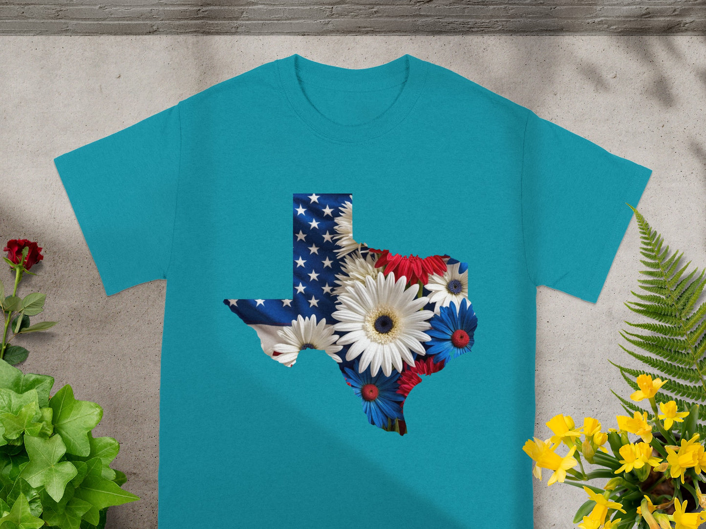 Teal t-shirt with Texas shape filled with American flag and red, white, blue flowers.