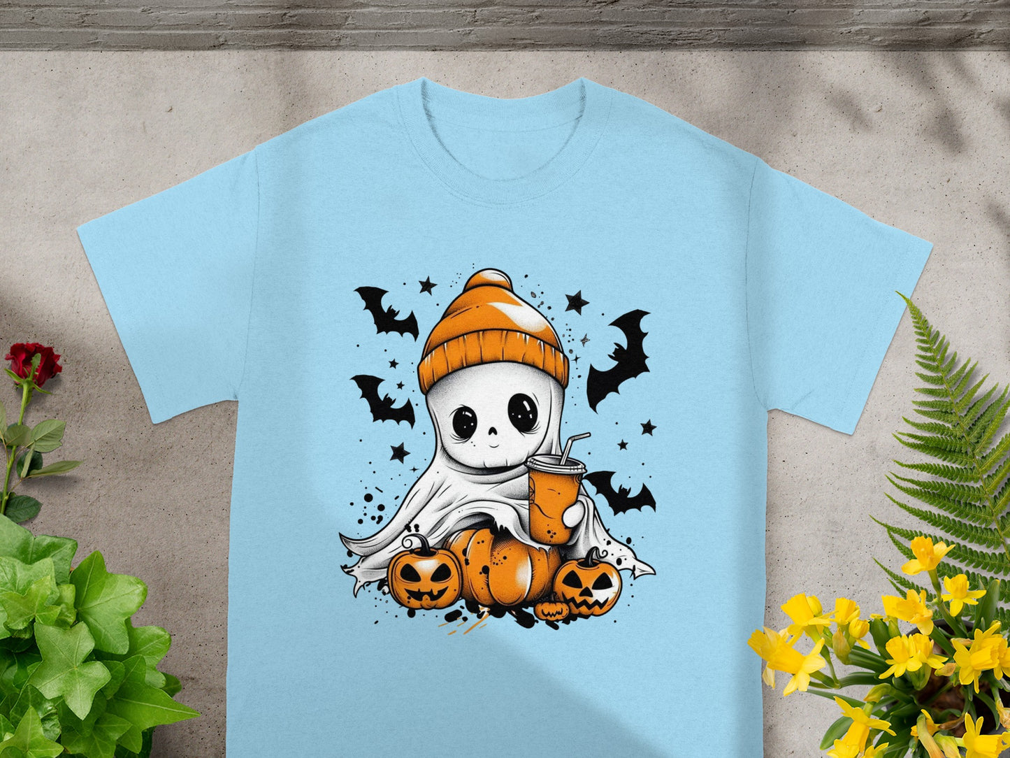 Light blue t-shirt with a cute ghost character, pumpkins, bats, and a drink.