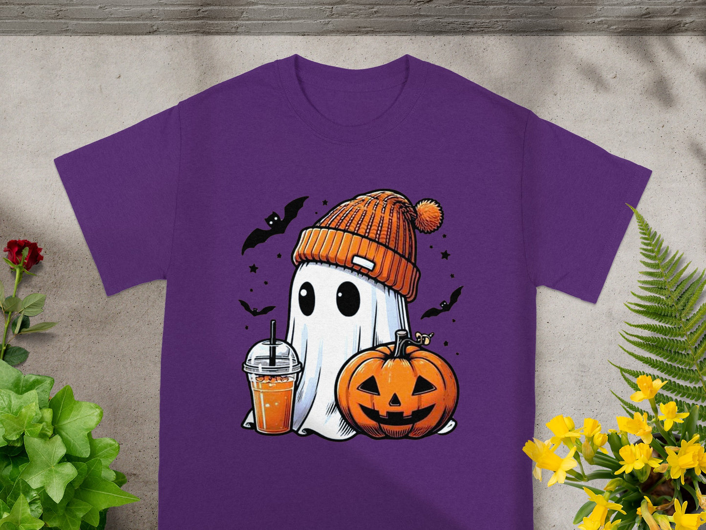 Purple t-shirt with cartoon ghost, pumpkin, drink, and bats.
