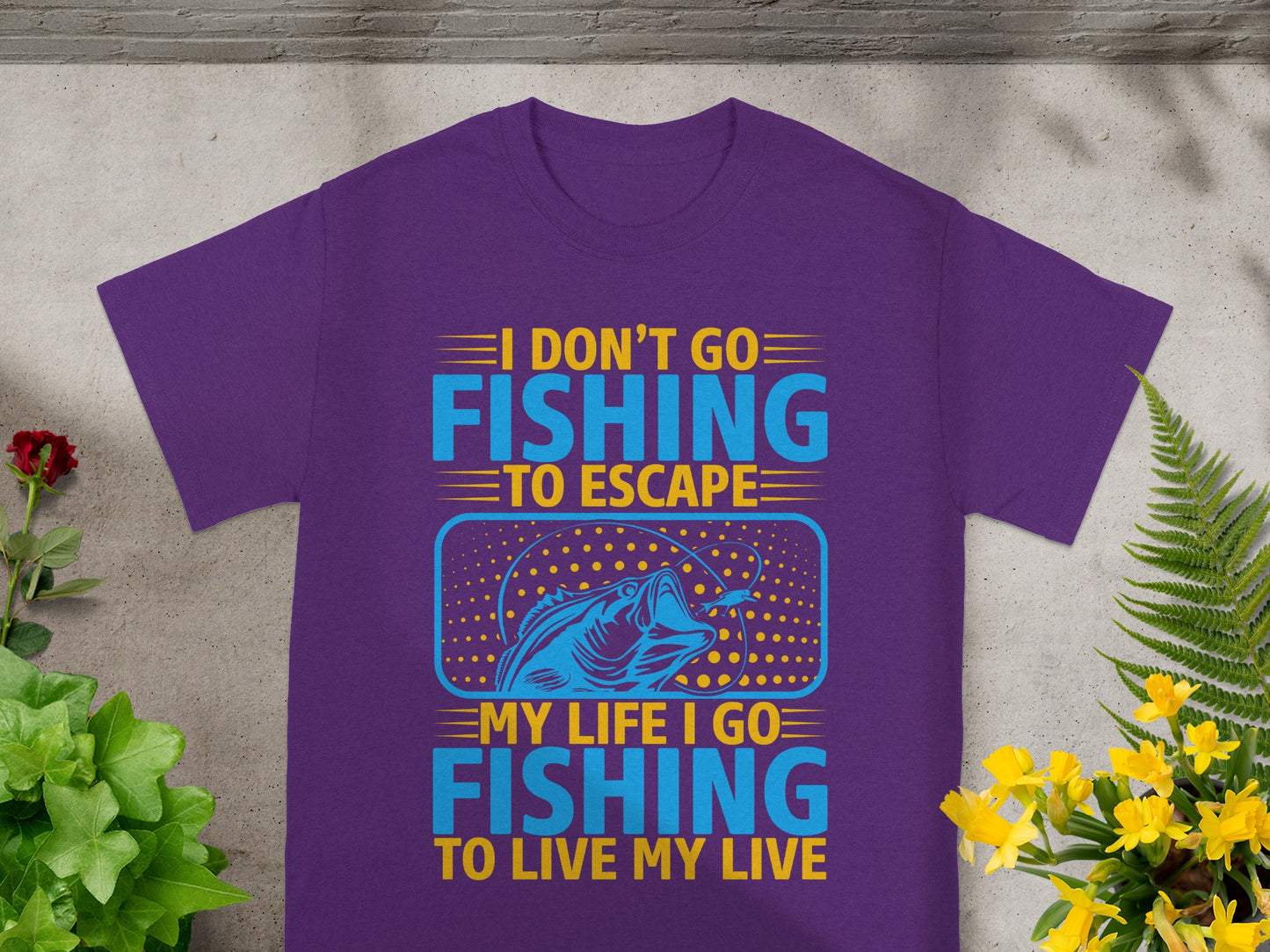 Purple t-shirt with "I don't go fishing to escape, my life I go fishing to live my live" text and fish graphic.