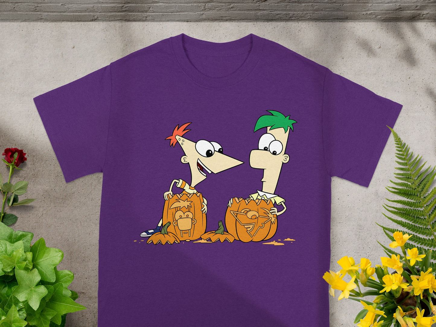 Phineas and Ferb with carved pumpkins on a purple t-shirt.