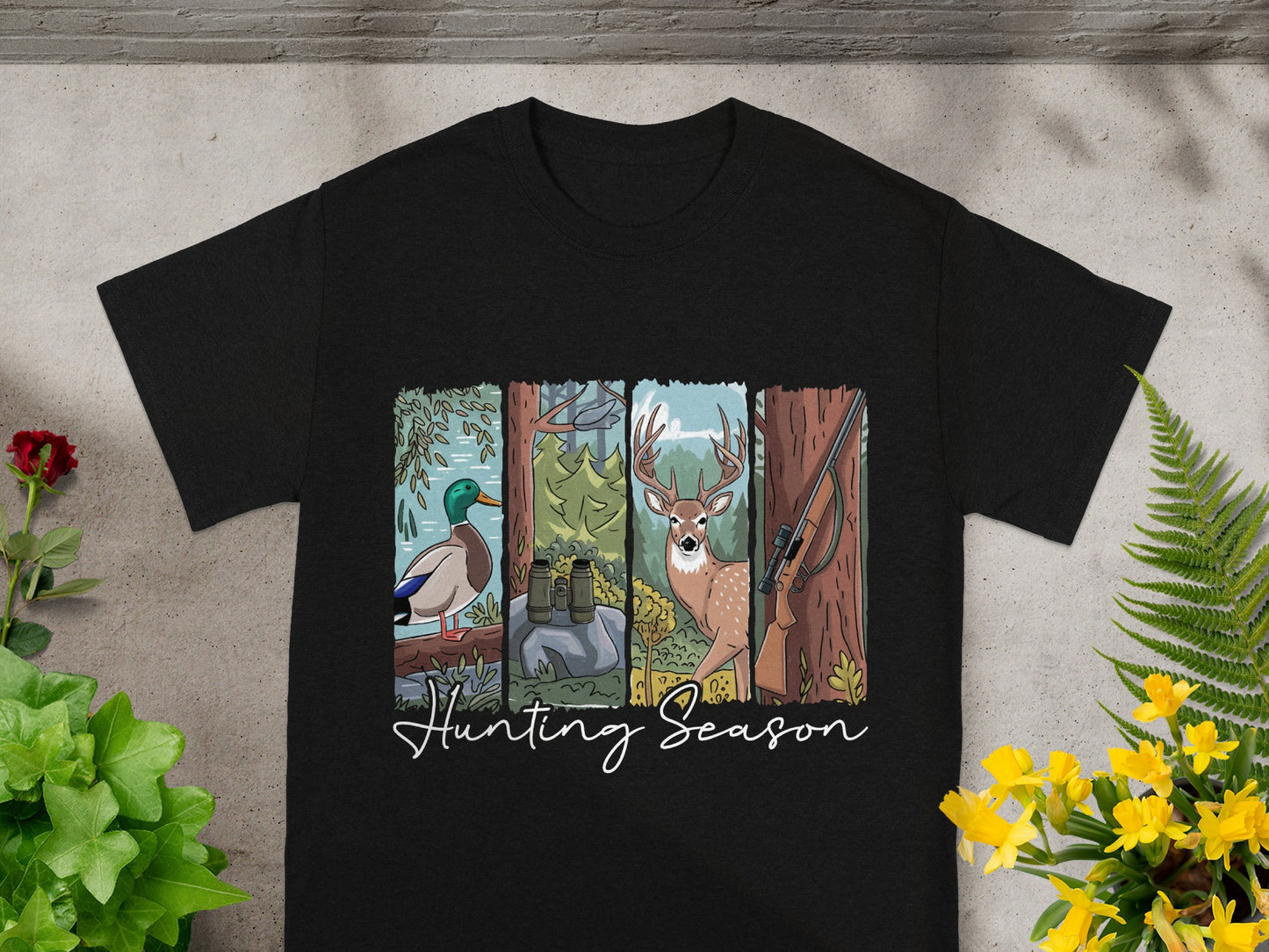 Black t-shirt with "Hunting Season" text and illustrations of a duck, binoculars, deer, and rifle.