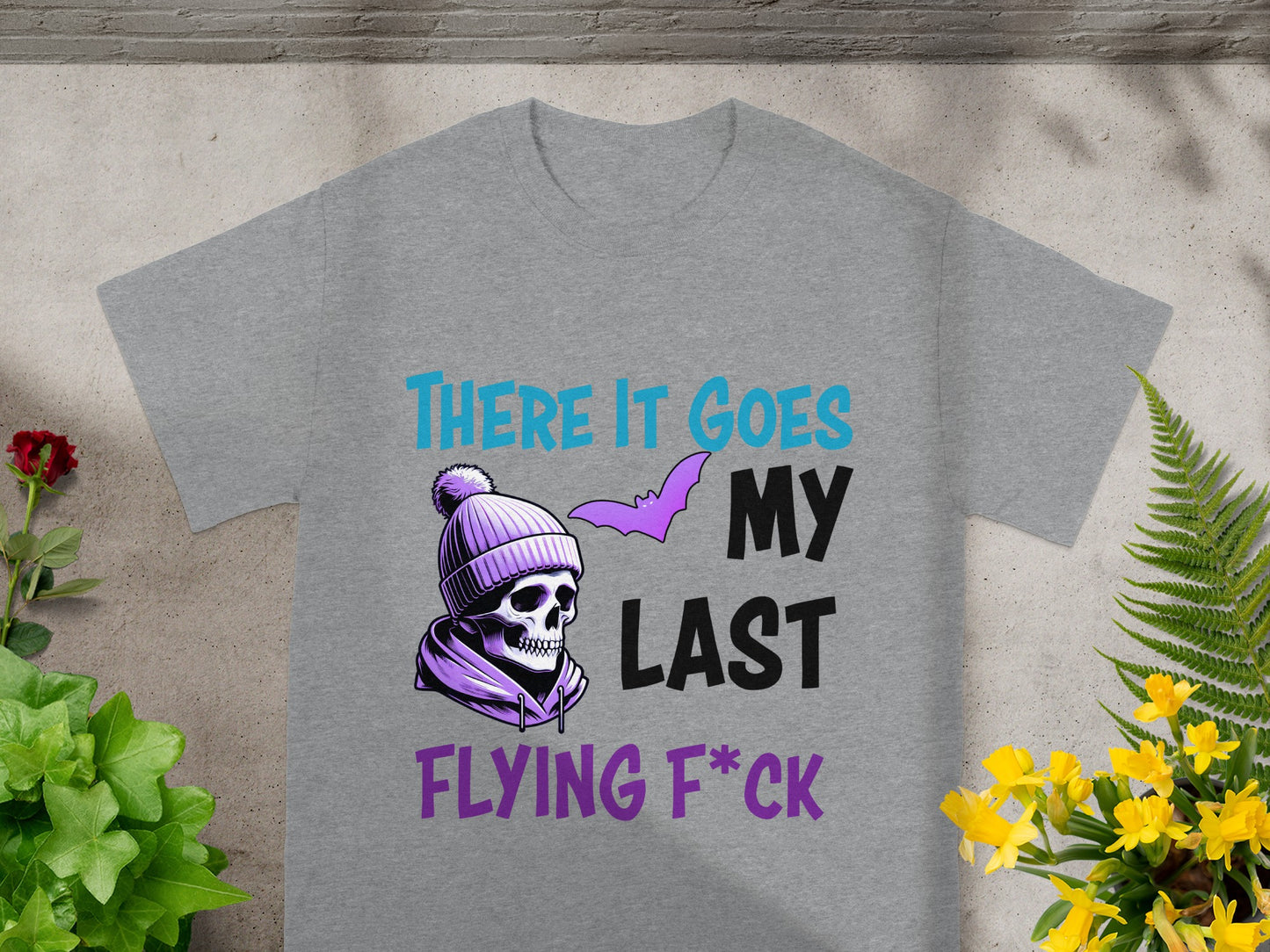 Grey t-shirt with skull in beanie, bat, and text "THERE IT GOES MY LAST FLYING F*CK".