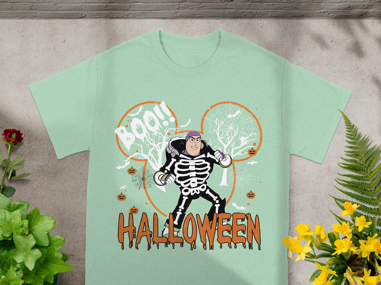 Light green t-shirt with Buzz Lightyear in skeleton costume and "Halloween" text.