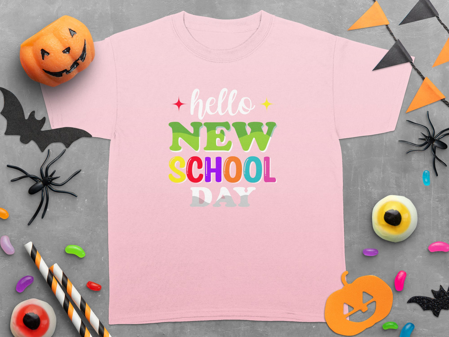 Pink t-shirt with "hello NEW SCHOOL DAY" text in colorful bubble letters.