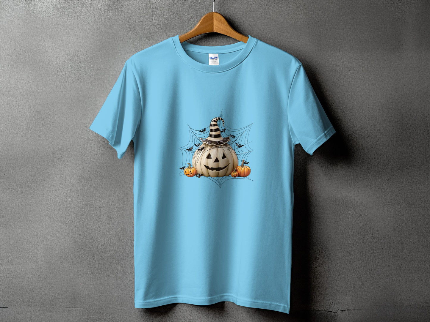 Light blue t-shirt with Halloween pumpkin, smaller pumpkins, bats, and cobwebs graphic.