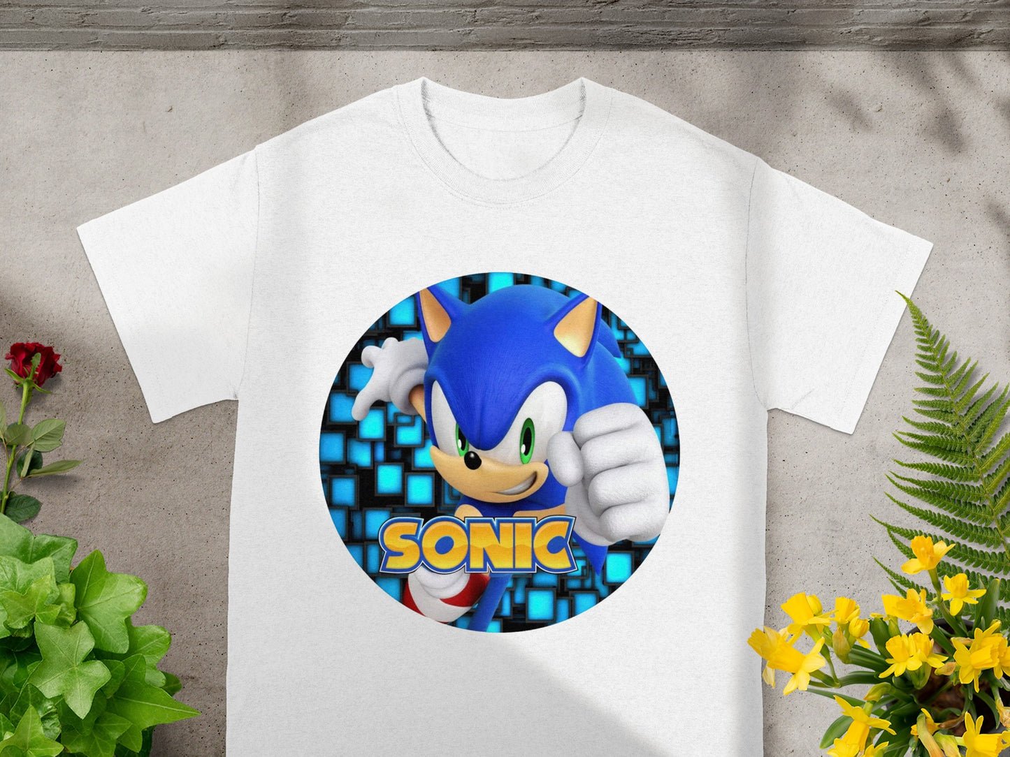 White t-shirt with Sonic the Hedgehog graphic in a blue, pixelated circle.