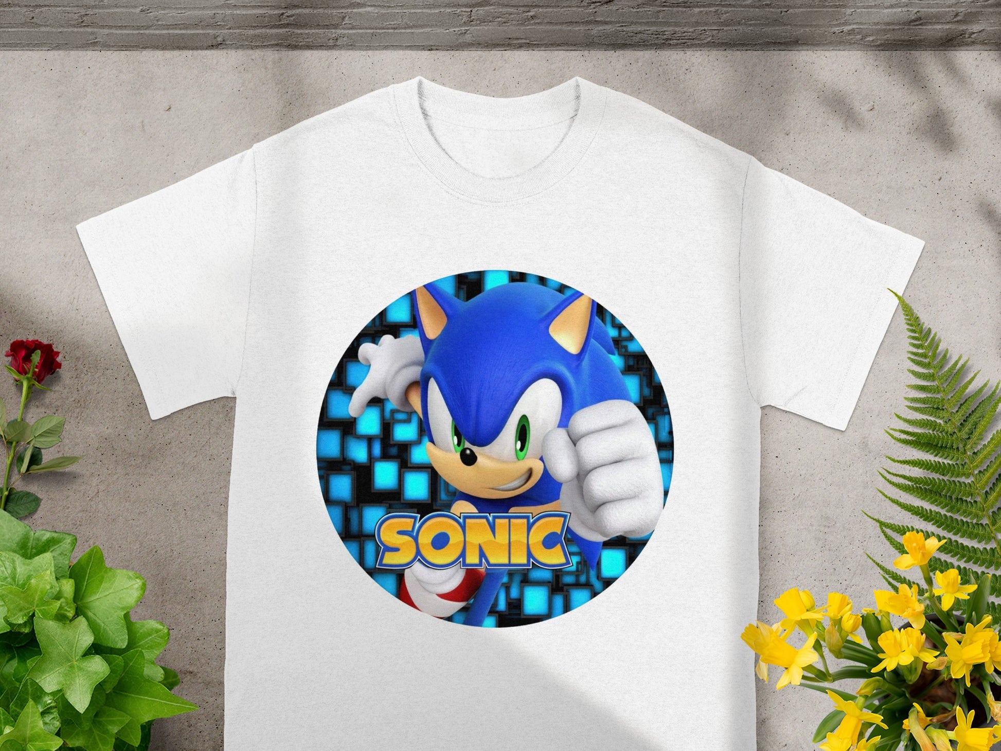 White t-shirt with Sonic the Hedgehog graphic in a blue, pixelated circle.