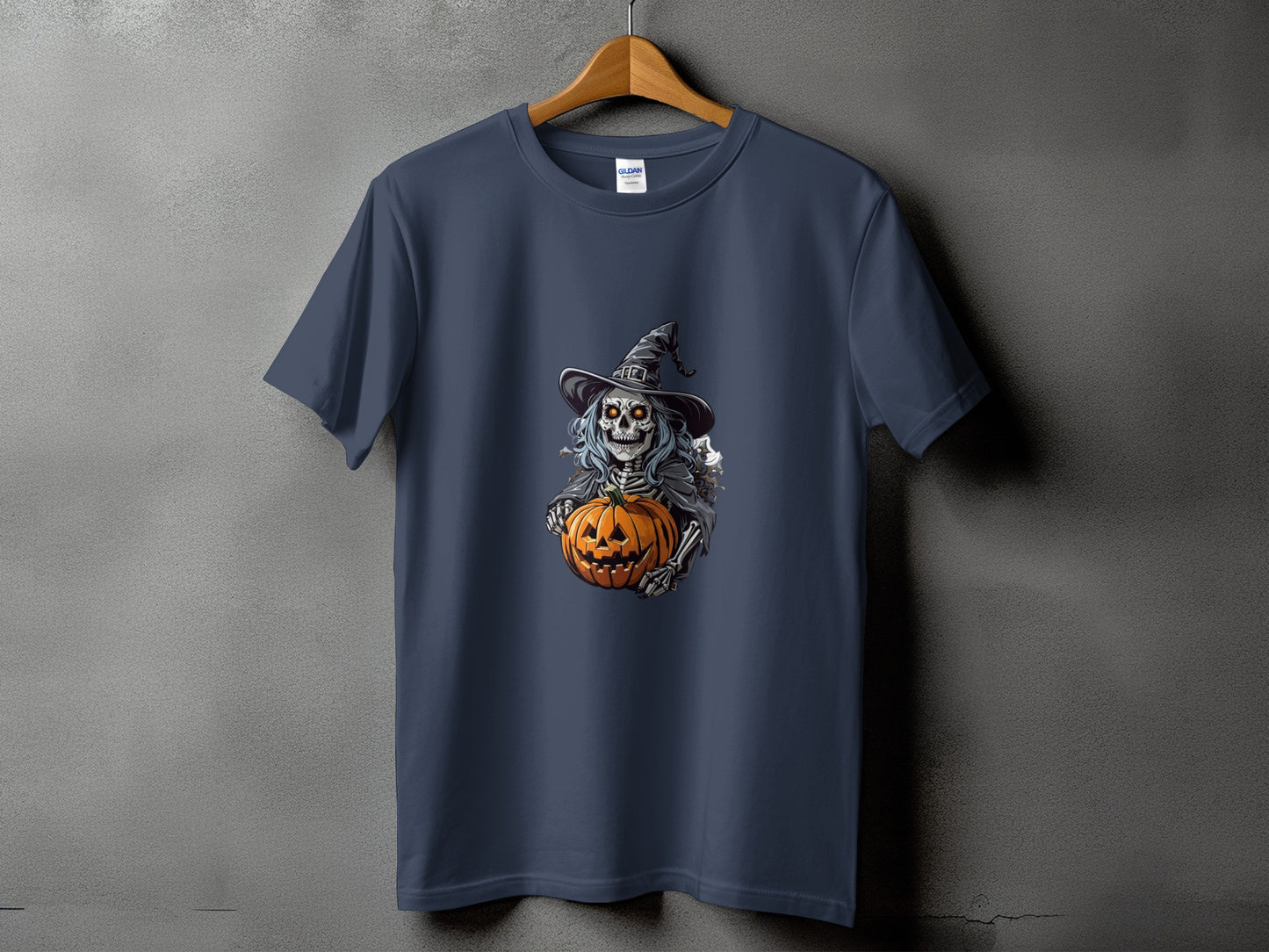 Dark blue t-shirt featuring a skeleton wearing a witch hat holding a pumpkin.
