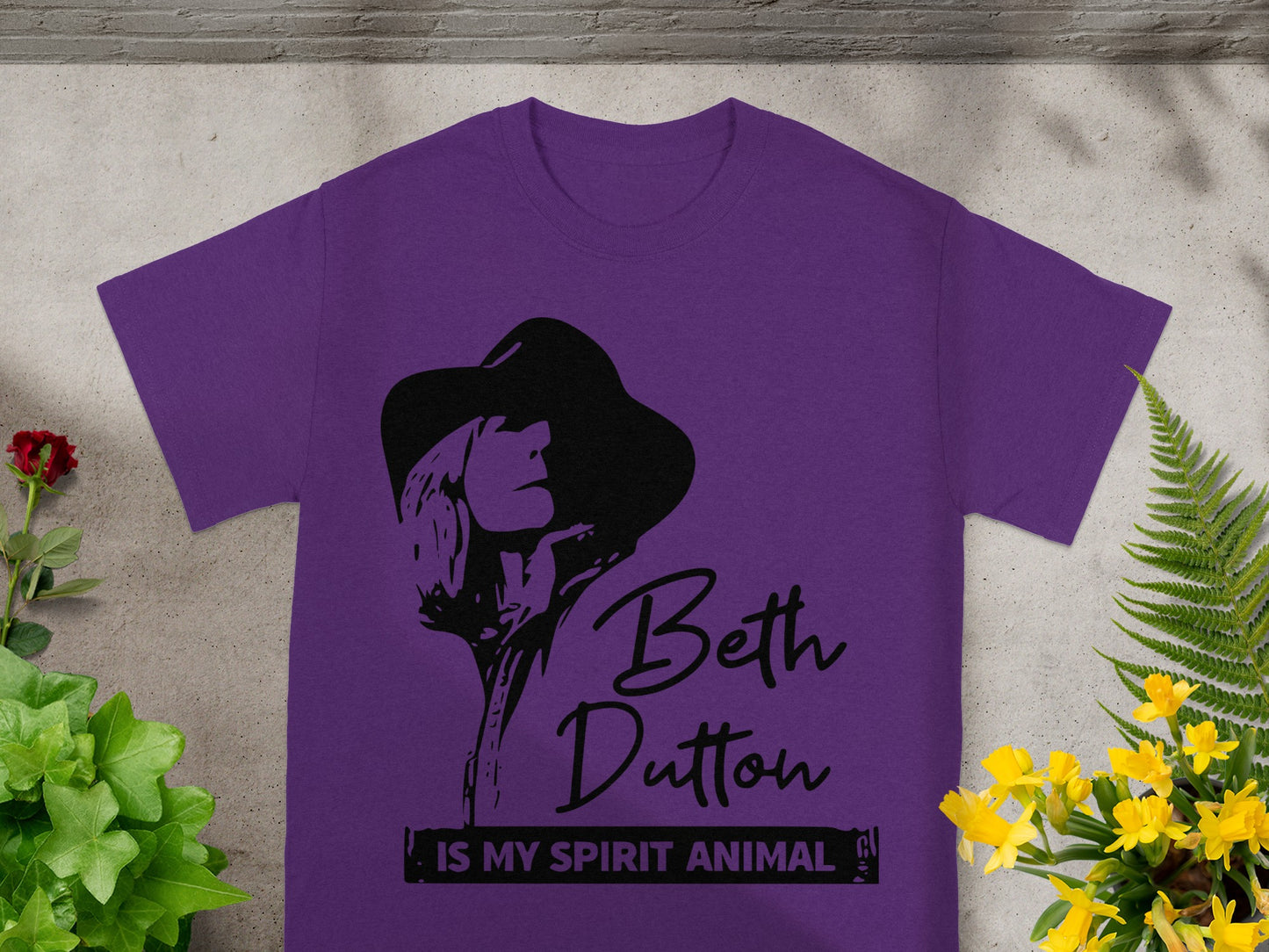 Purple t-shirt with black Beth Dutton graphic and text.