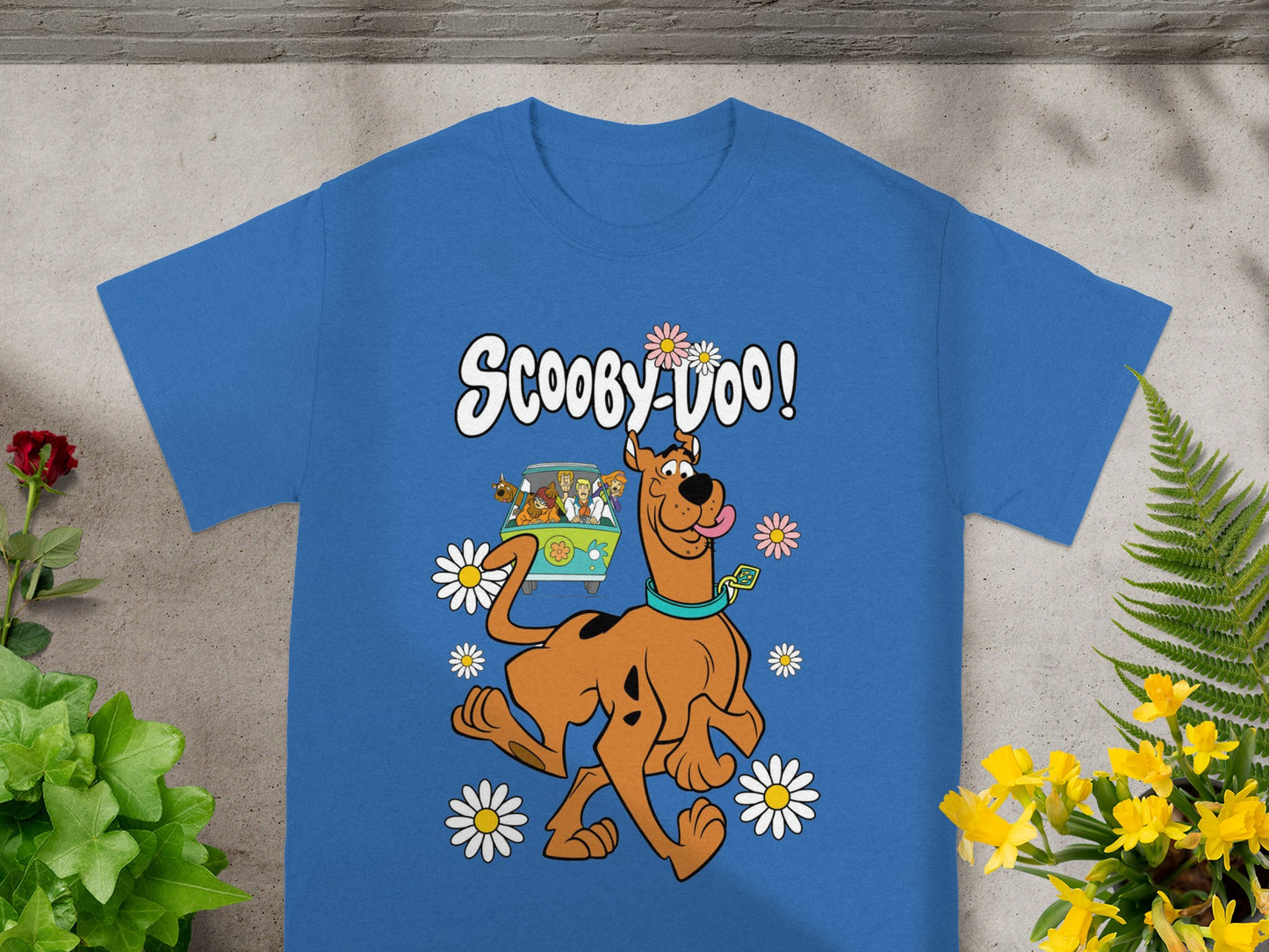 Scooby-Doo! text and characters with flowers on a blue t-shirt.