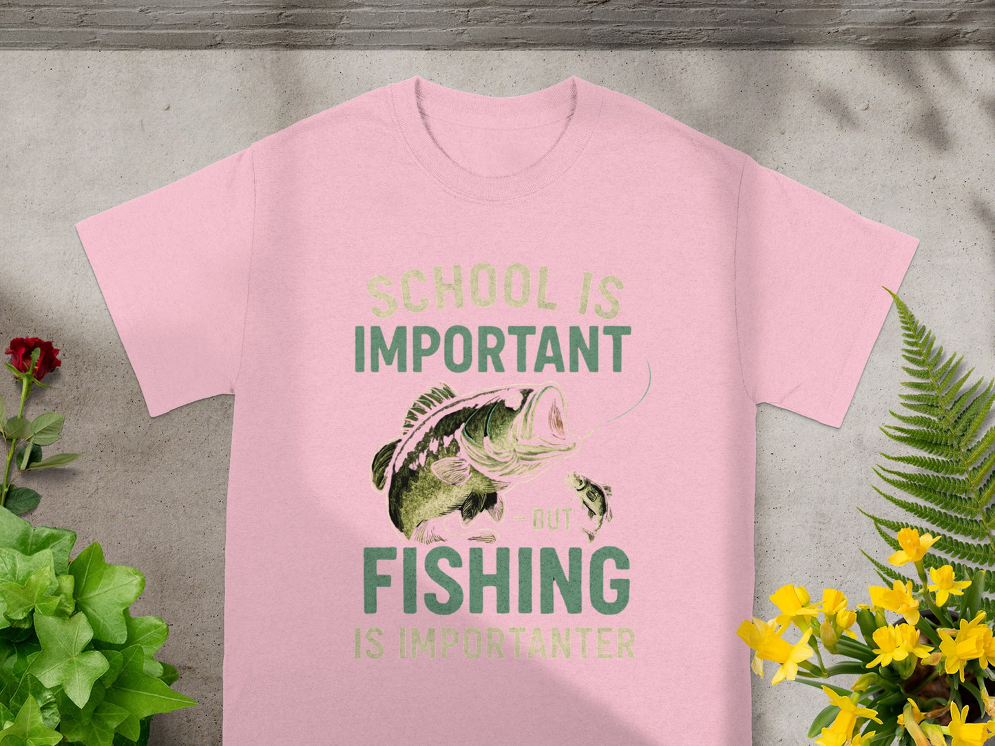 Pink t-shirt with text "School is important but fishing is importanter" and fish graphic.